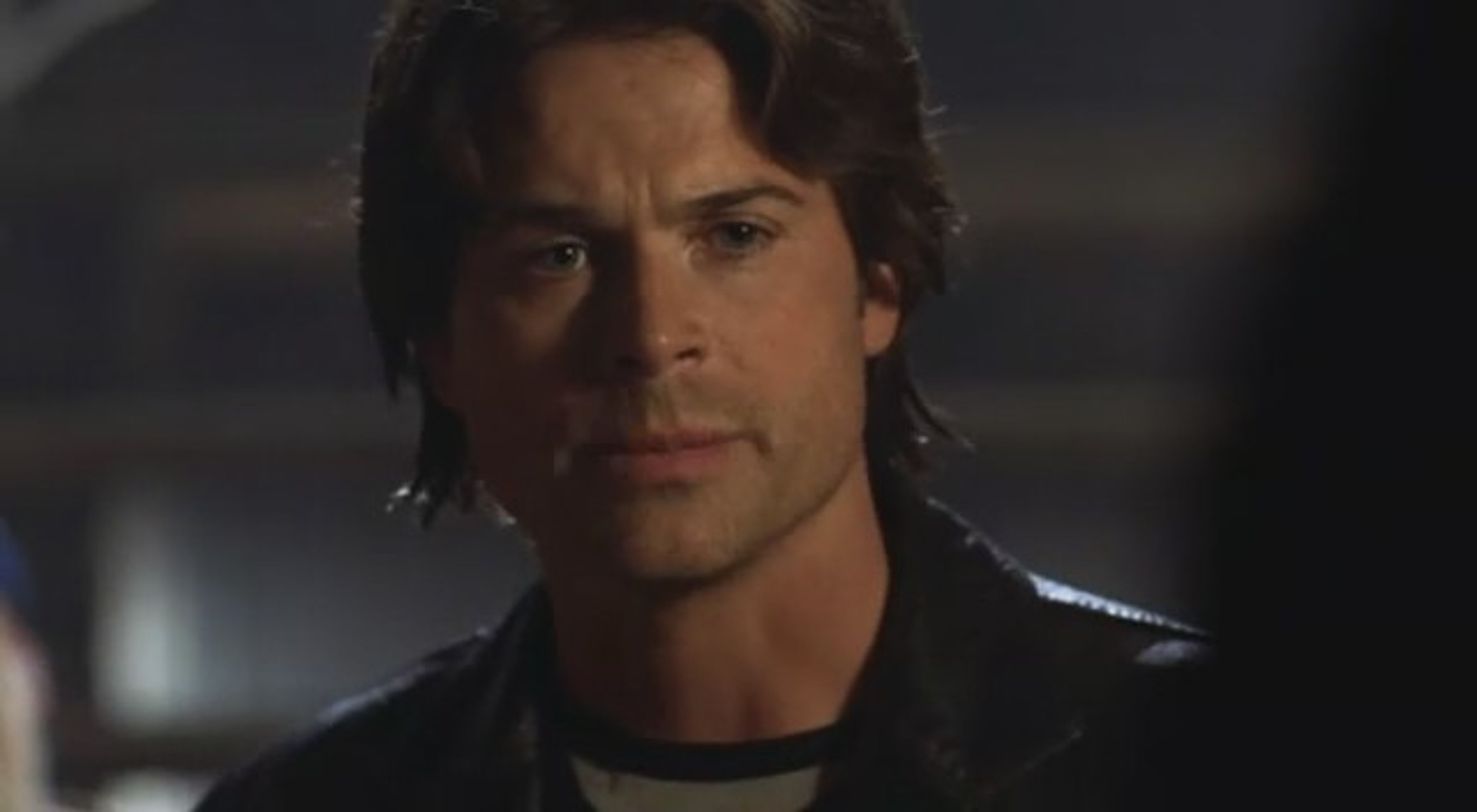 A middle-aged man with a serious, haunted expression