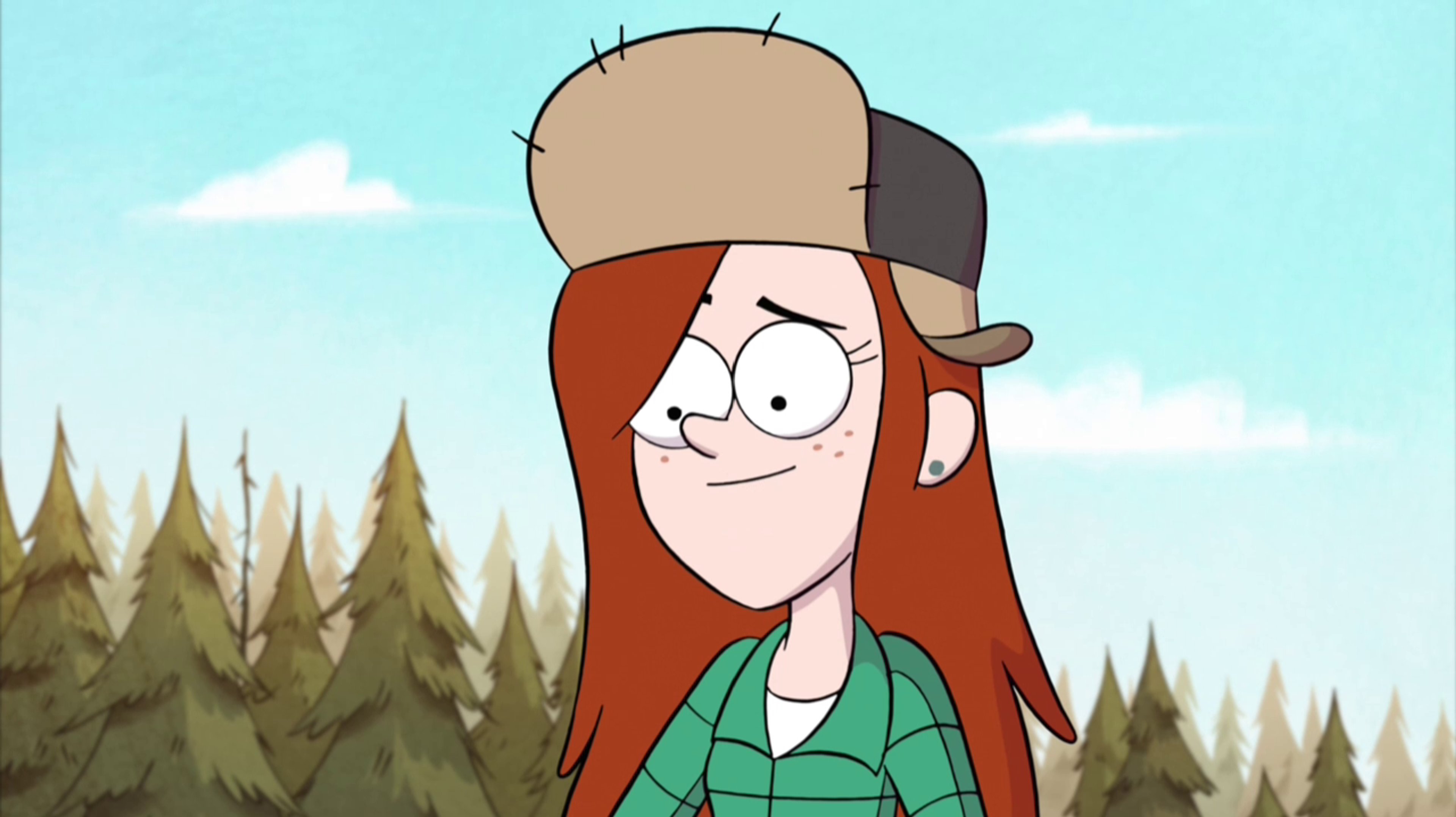 A teenage girl with red hair wearing a flannel shirt and hat in a forested setting