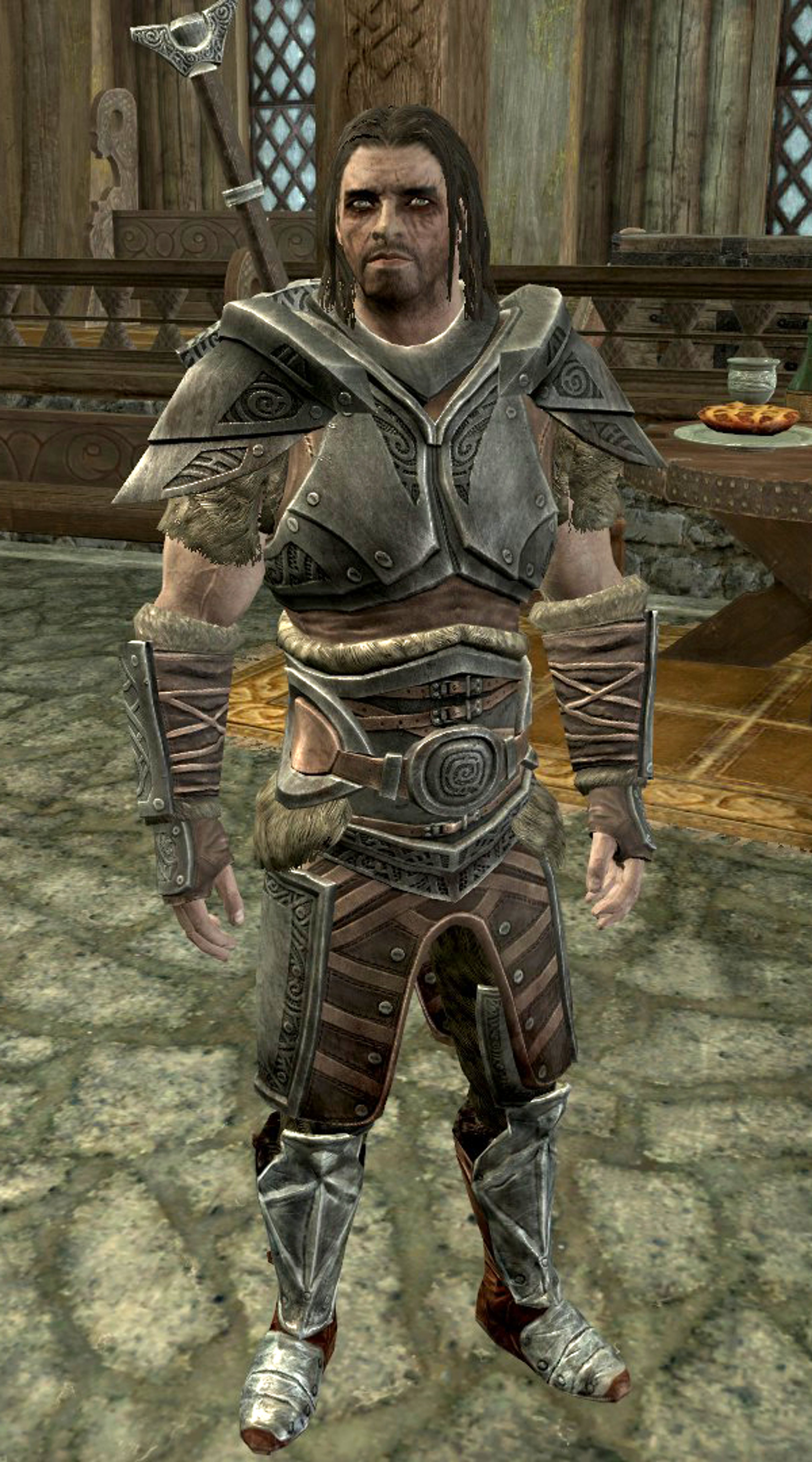 A Nord warrior in heavy armor standing in a medieval-style interior