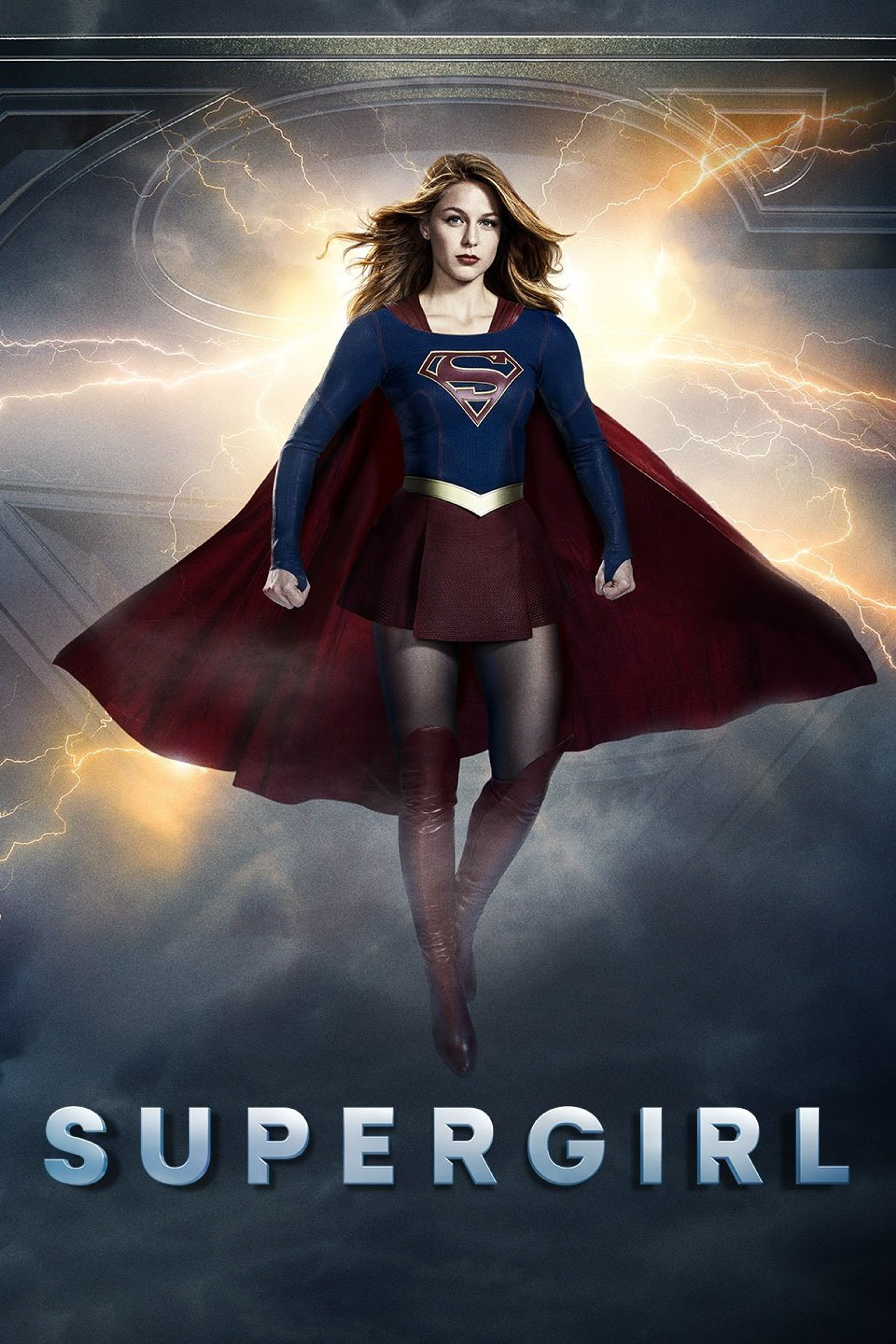 A woman in a Supergirl costume standing heroically against a stormy sky background.