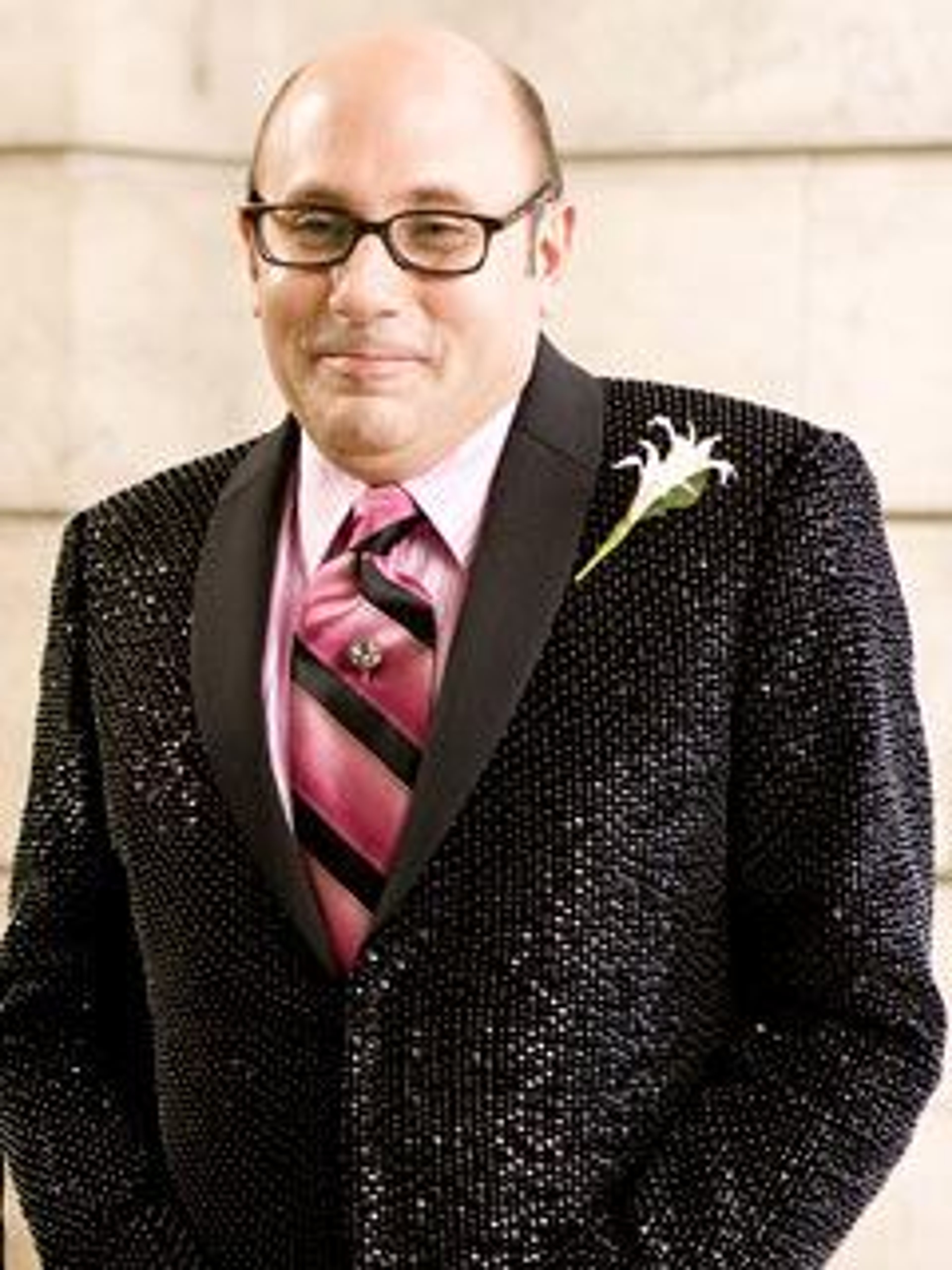 A well-dressed middle-aged man with a serious expression