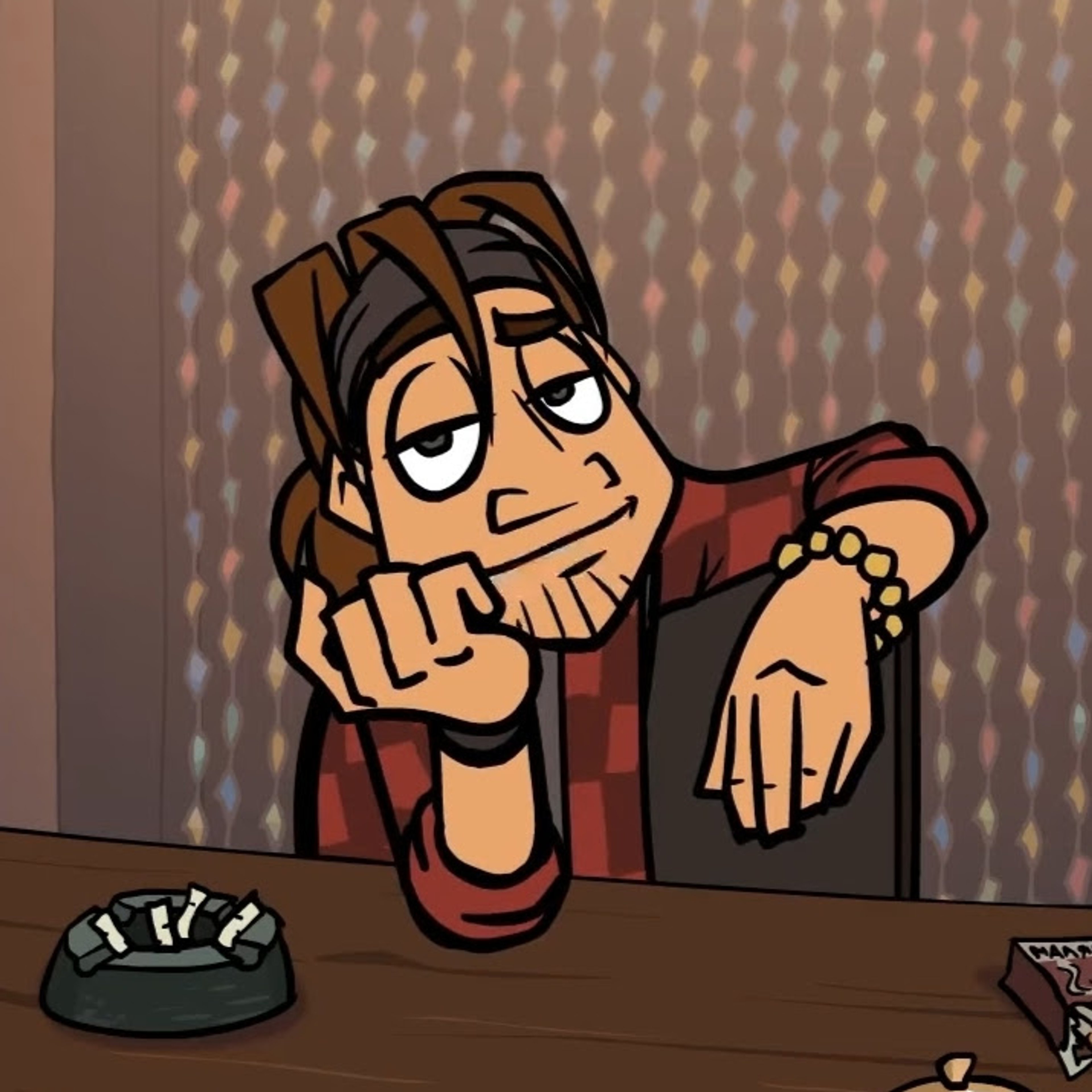 A quirky, unconventional-looking character with long hair, a beard, and an eccentric fashion sense sitting at a desk or table.