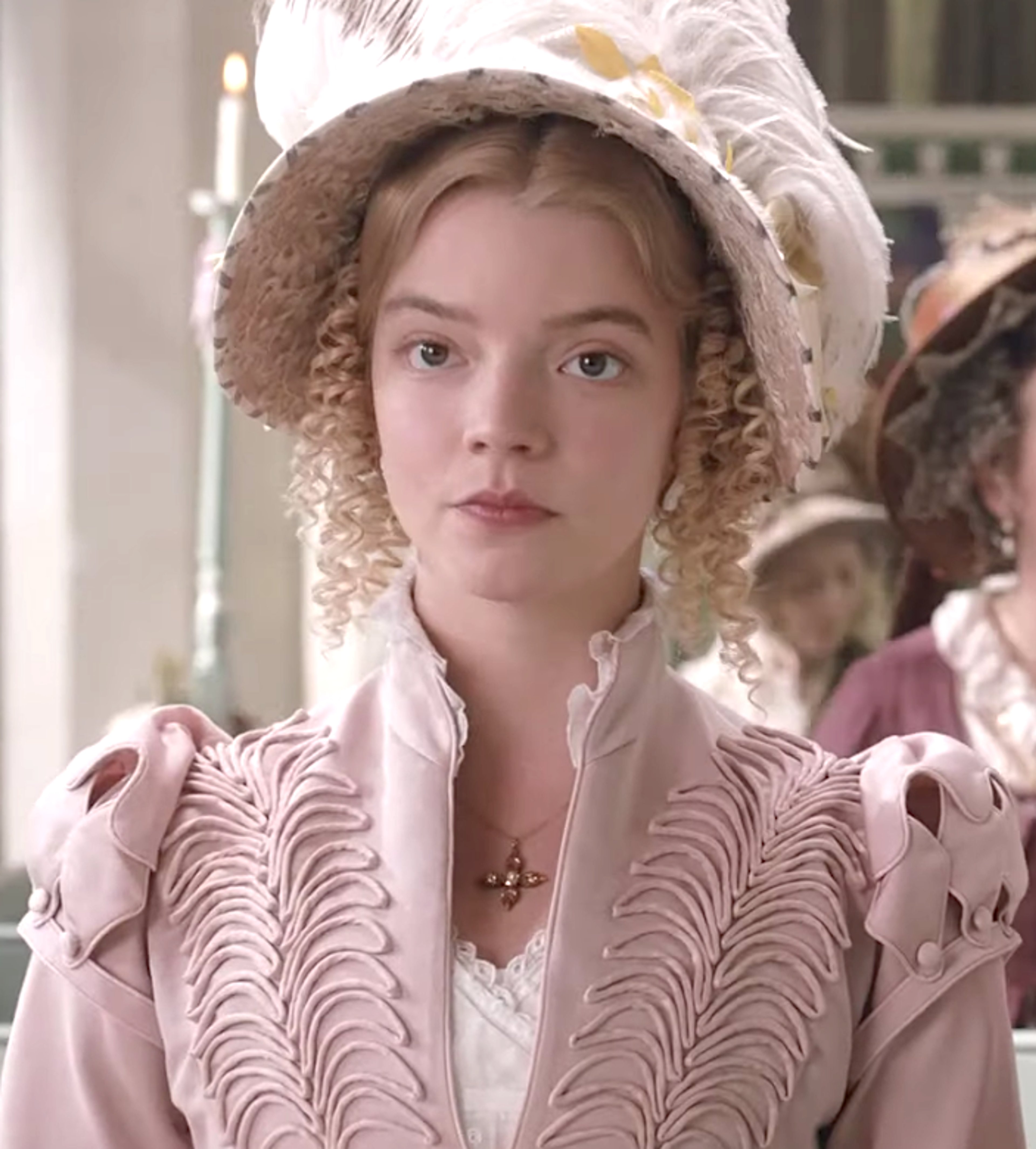 A young woman in a pink dress and bonnet from the early 19th century