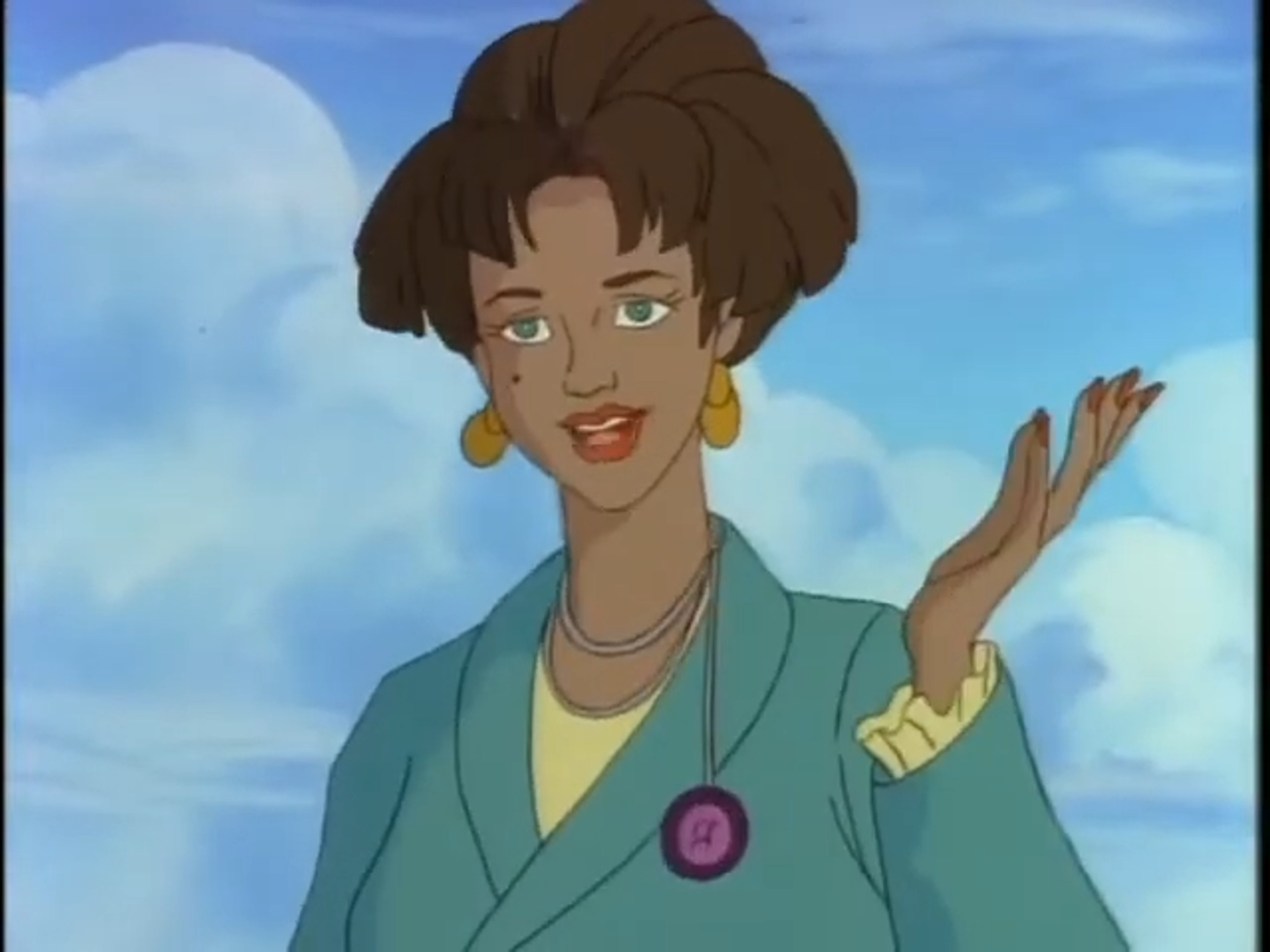 A woman with curly brown hair styled in a professional bob haircut, wearing a green blazer and smiling confidently.