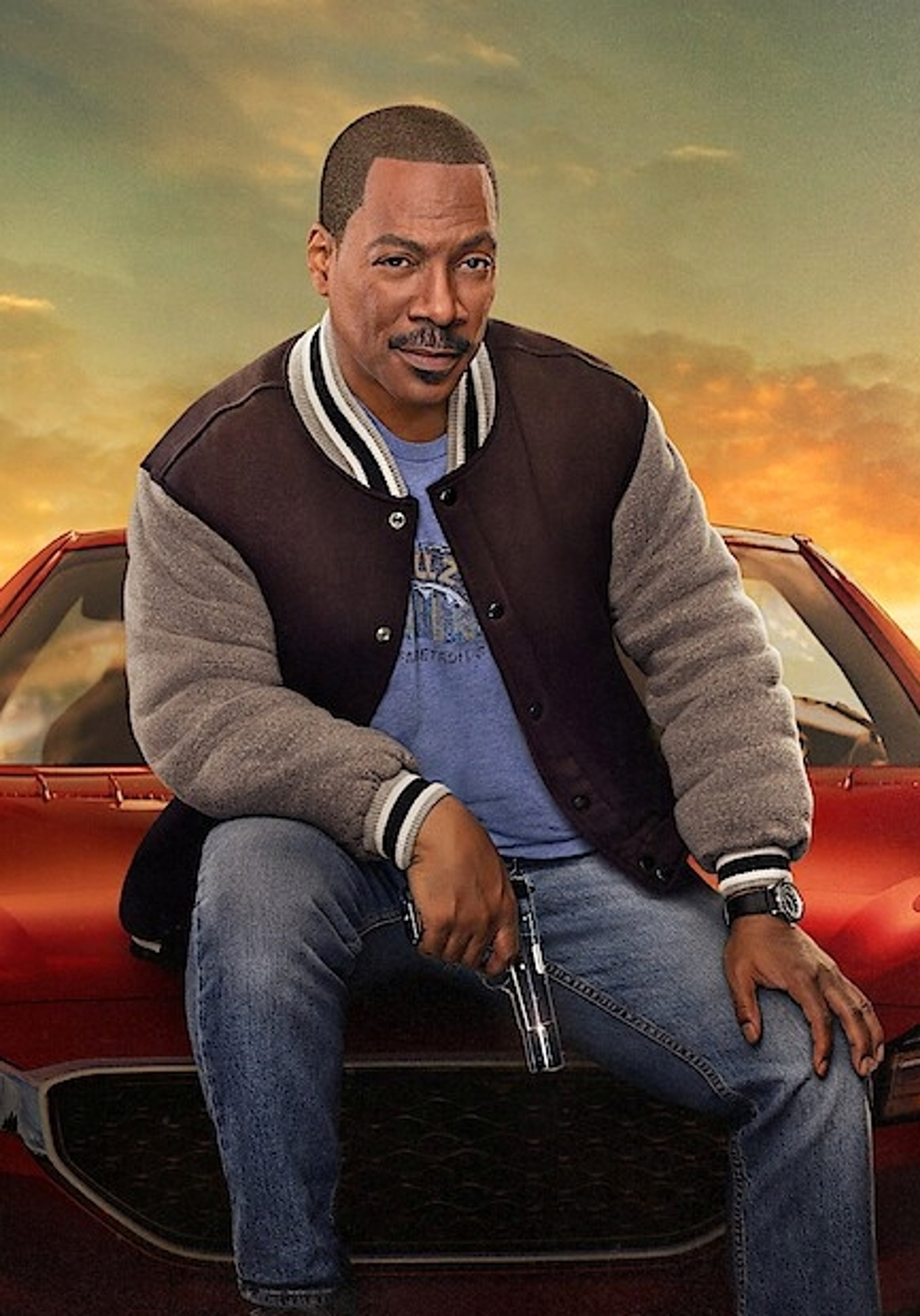 A middle-aged Black man sitting in the driver's seat of a red car