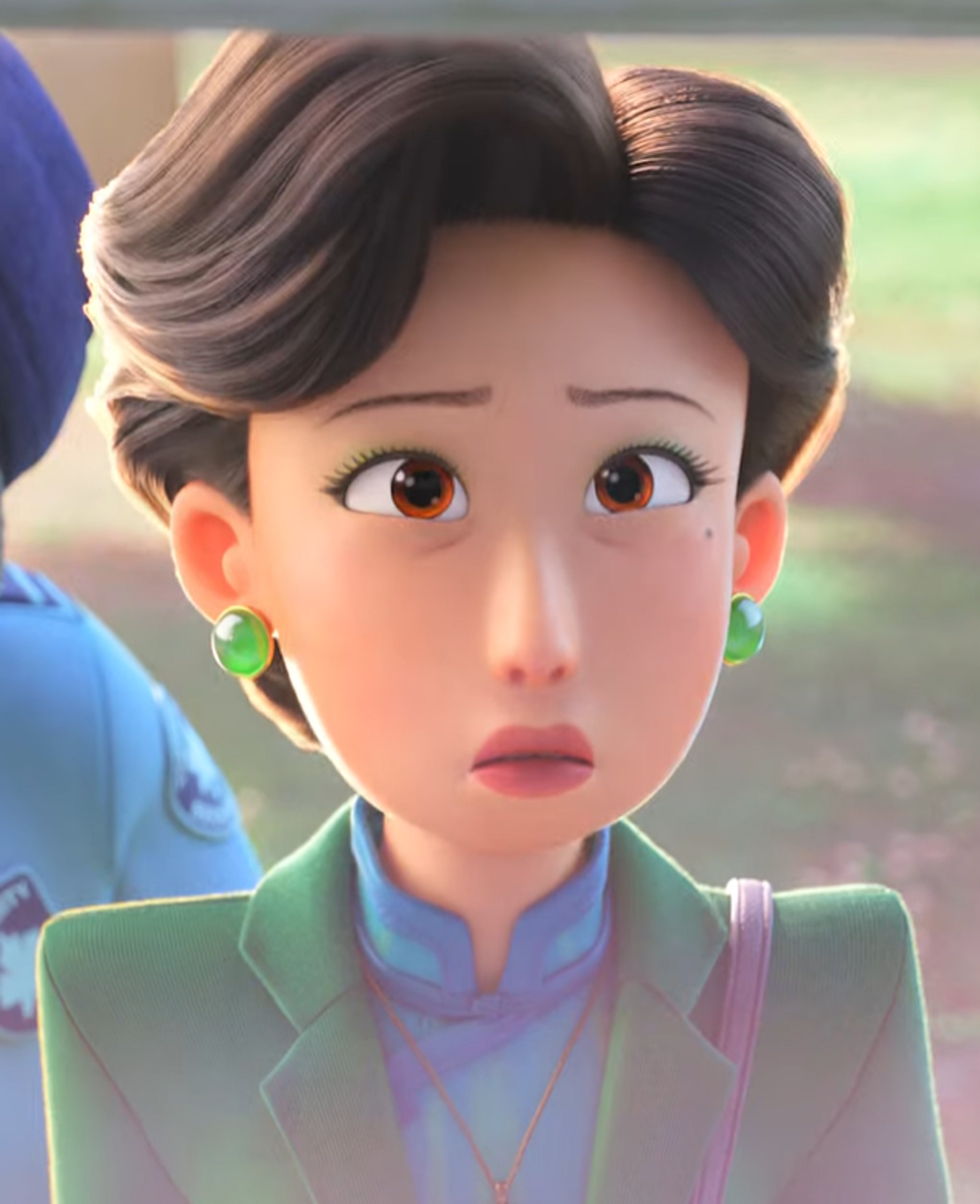 An animated female character with dark hair in an updo, wearing a green jacket and purple top, with a concerned expression on her face.