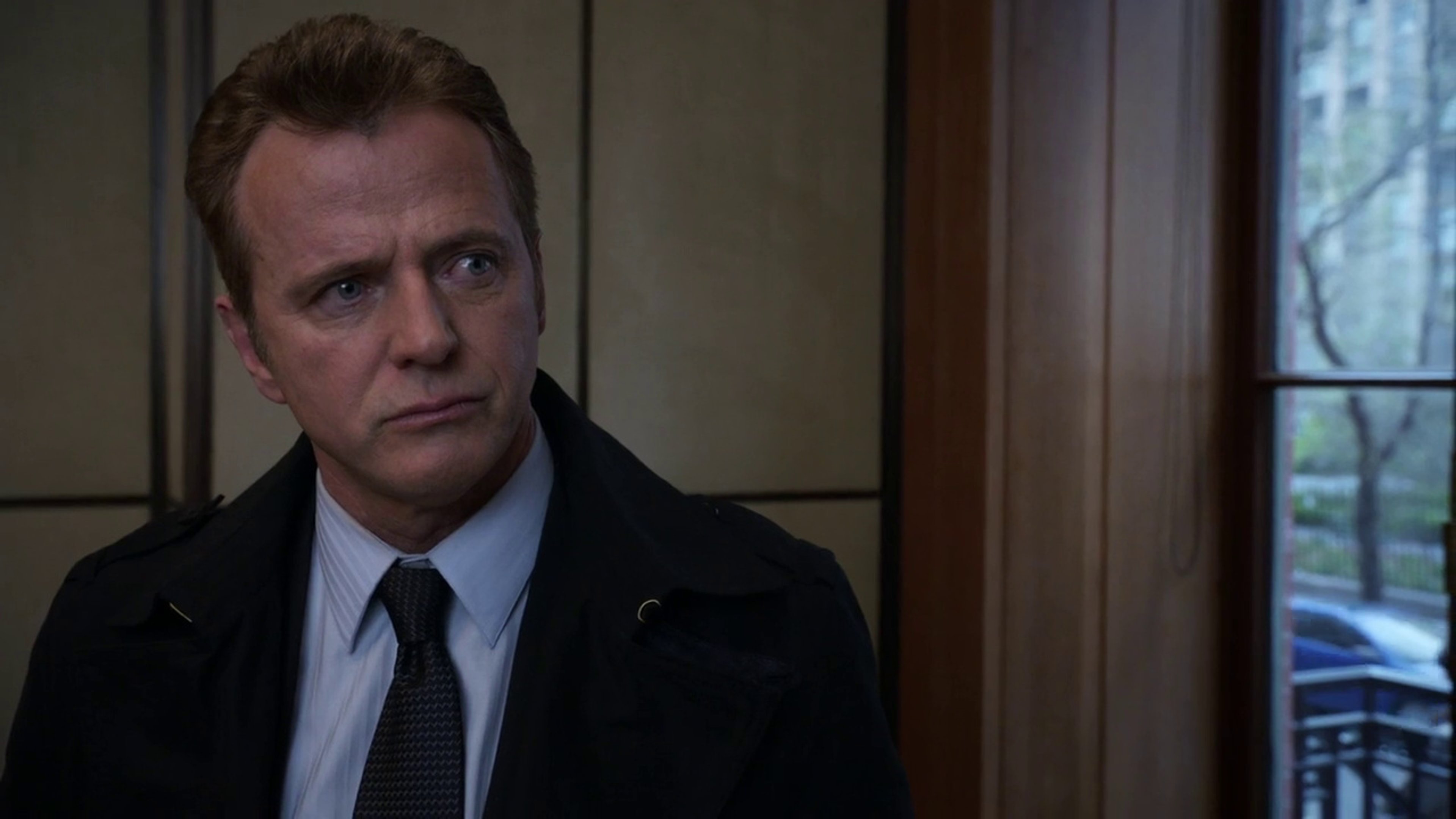 A serious-looking middle-aged man in a suit