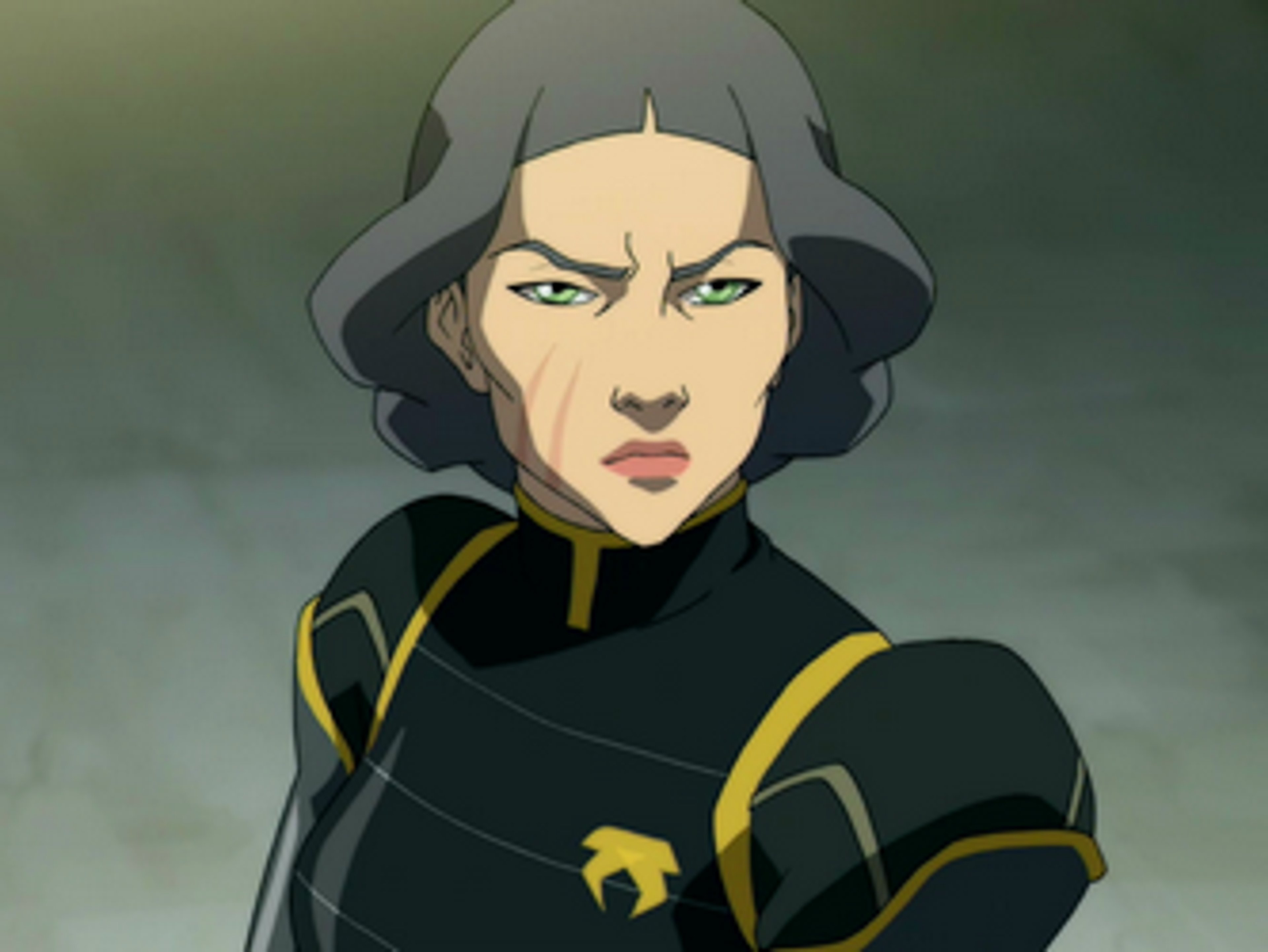 A woman in a black and yellow uniform with a stern expression