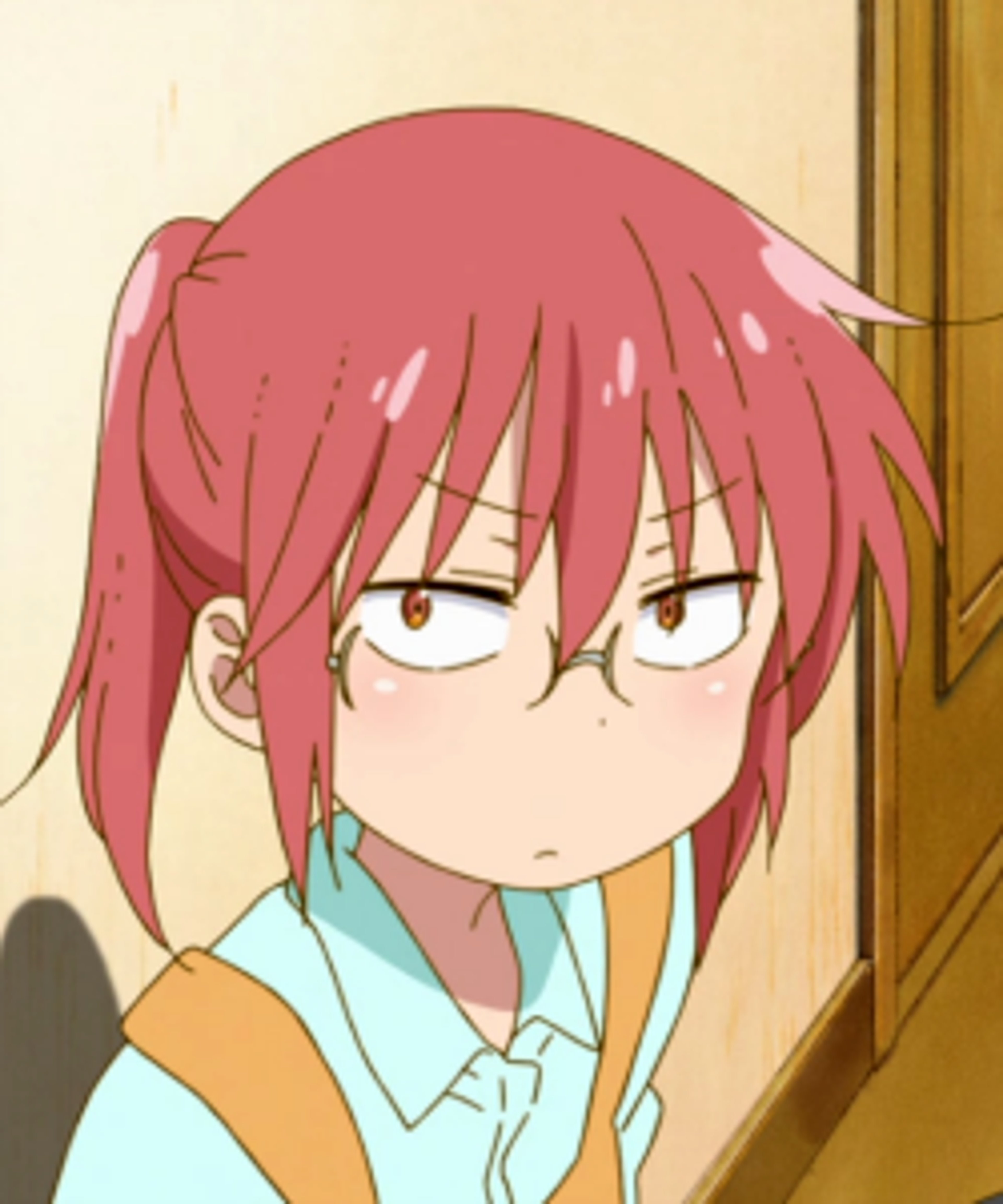 A young woman with pink hair and a frustrated expression