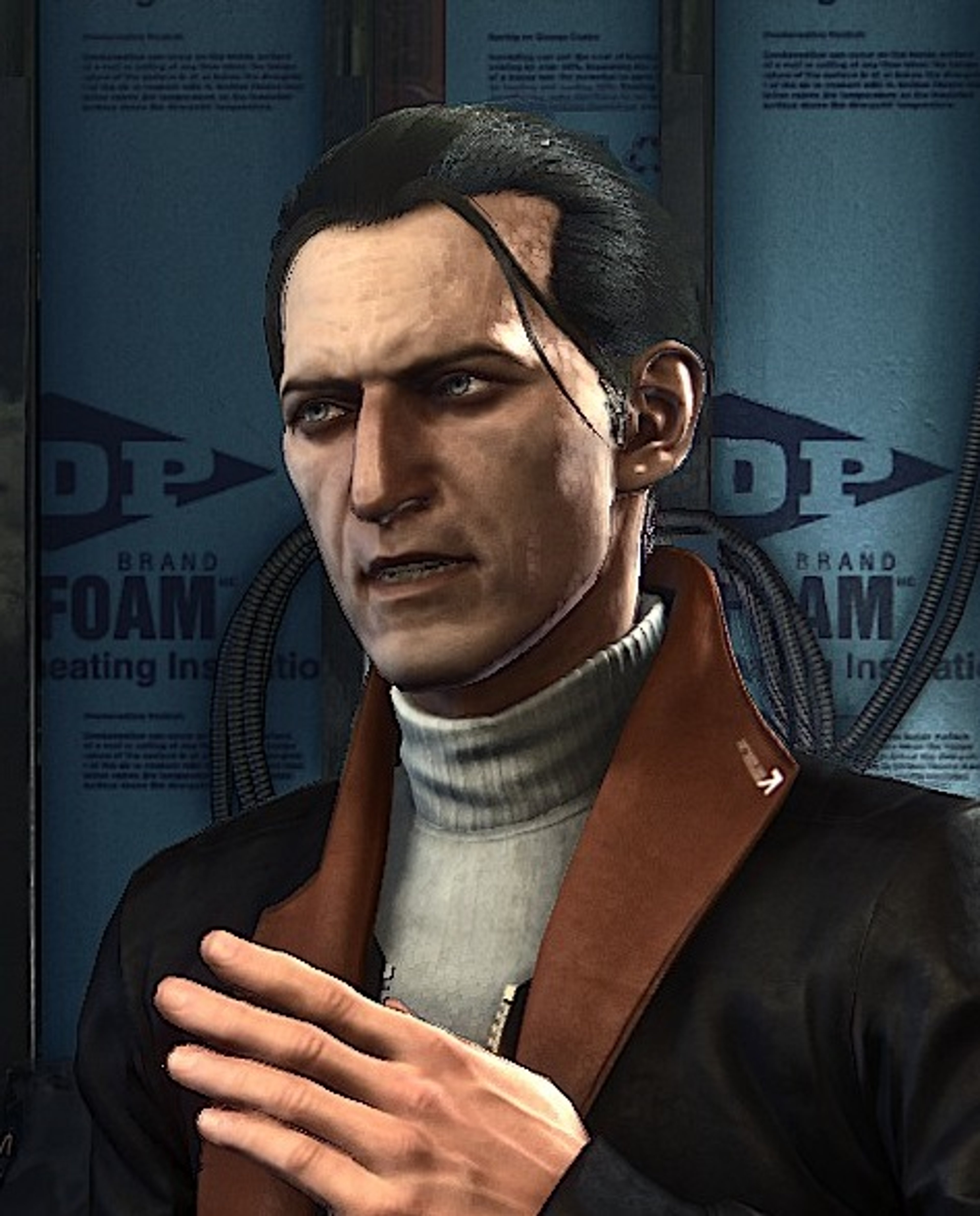 A man with short dark hair wearing a brown jacket and turtleneck sweater in a professional setting