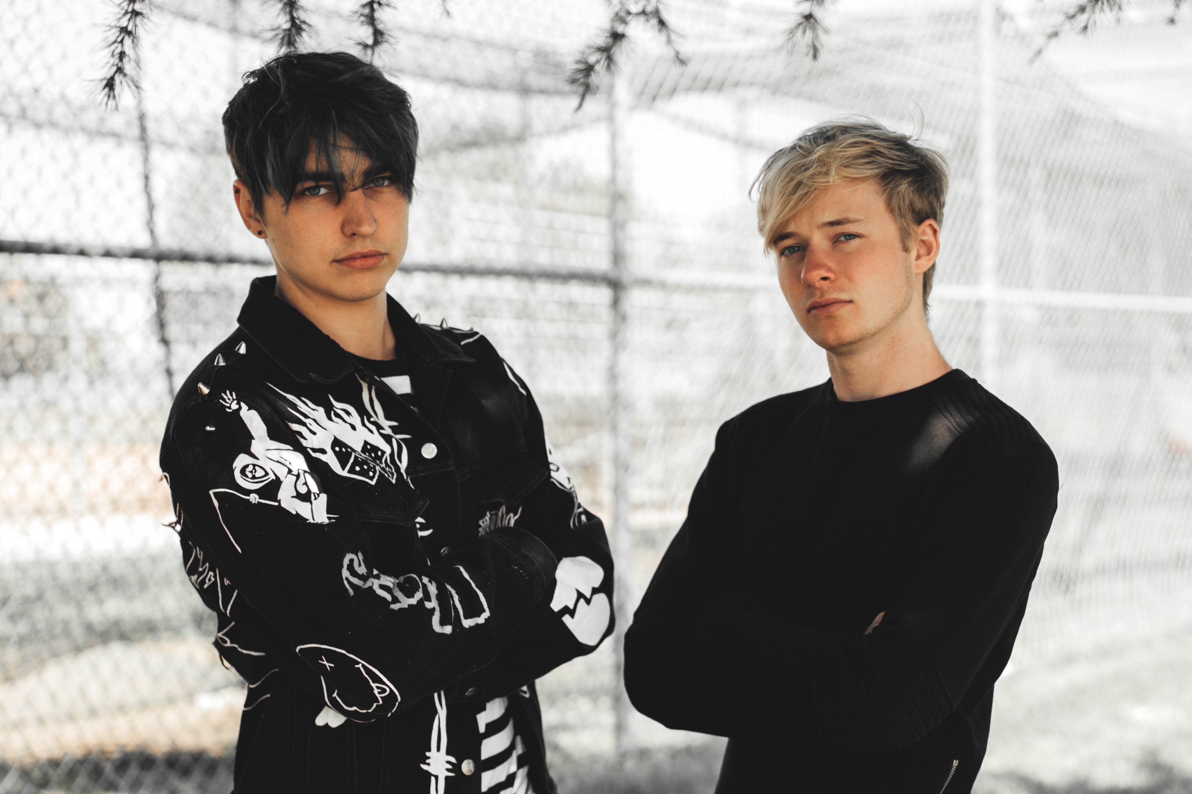 Two young men standing together outdoors