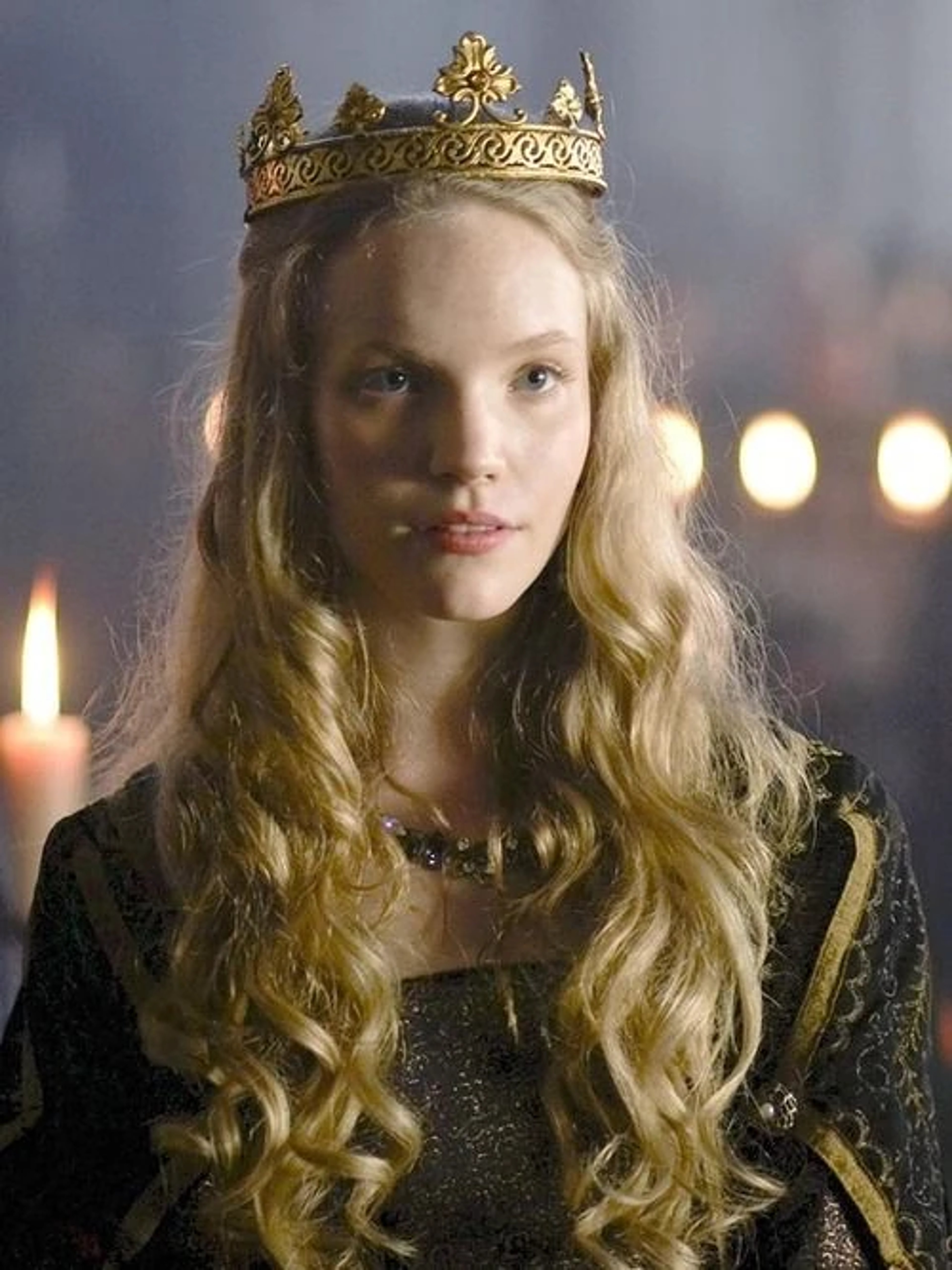 A young woman with long blonde hair wearing a golden crown