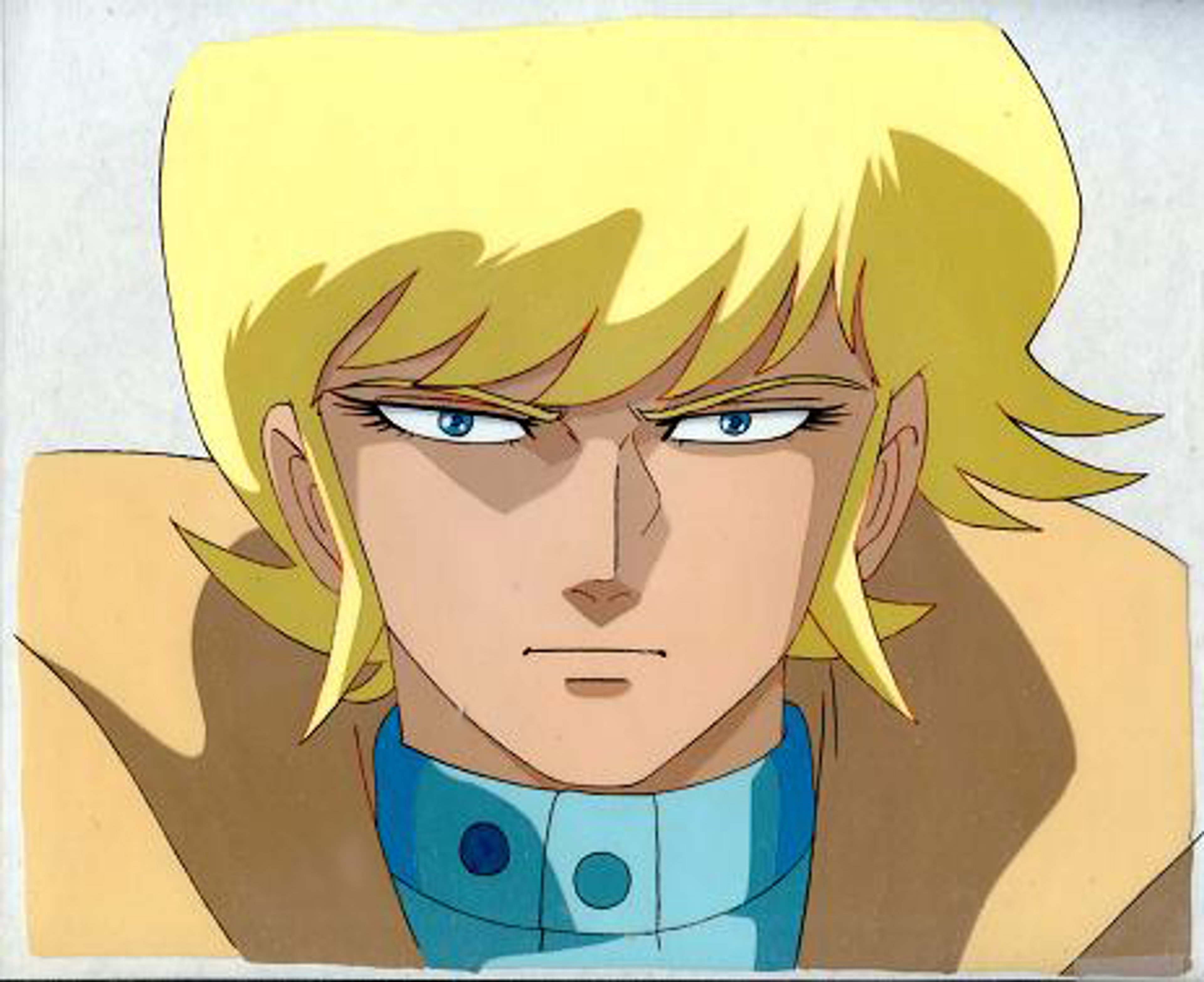 A young man with blonde hair and blue eyes wearing a blue shirt