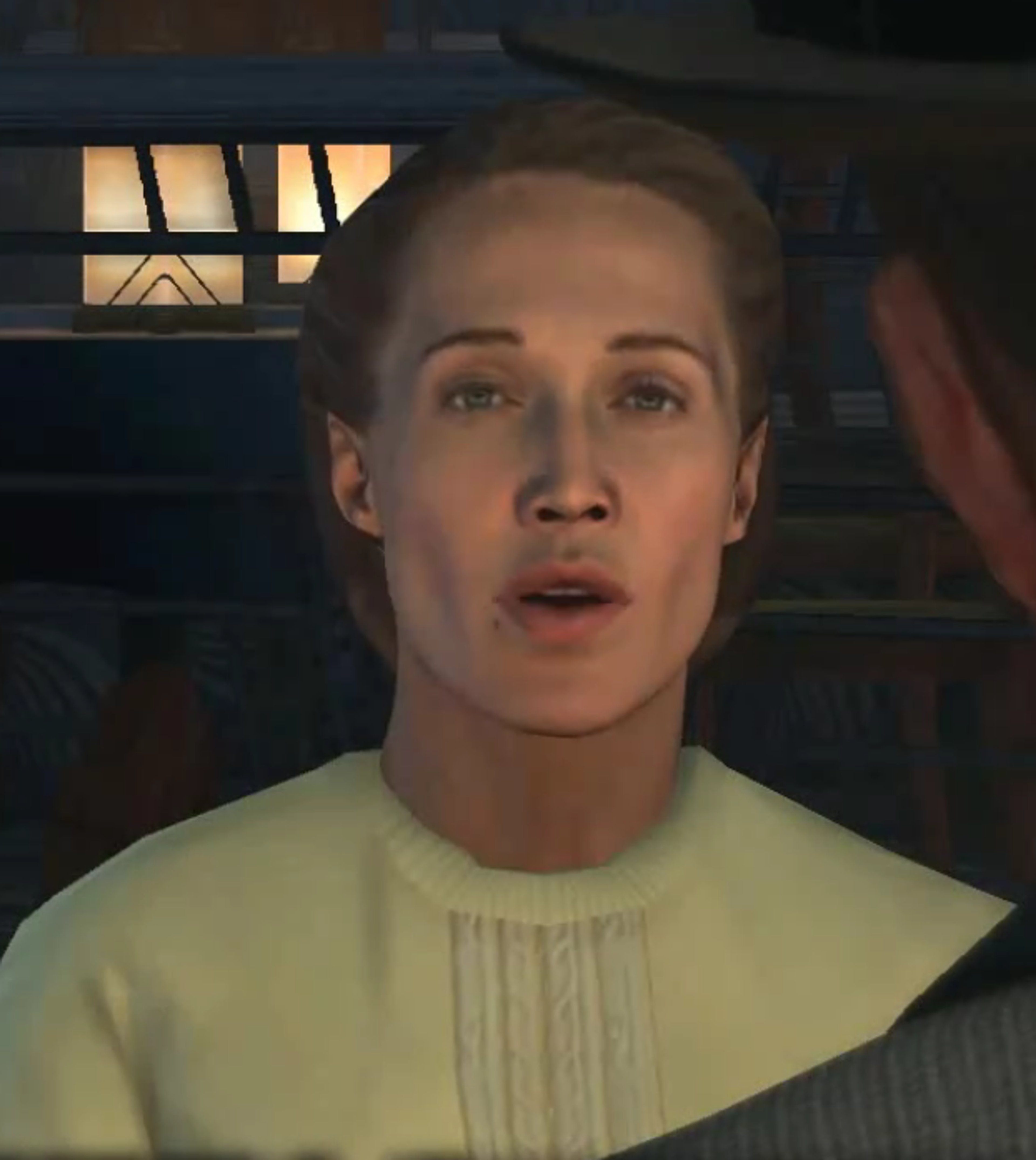 A woman with a serious expression on her face, wearing a light-colored shirt or dress.