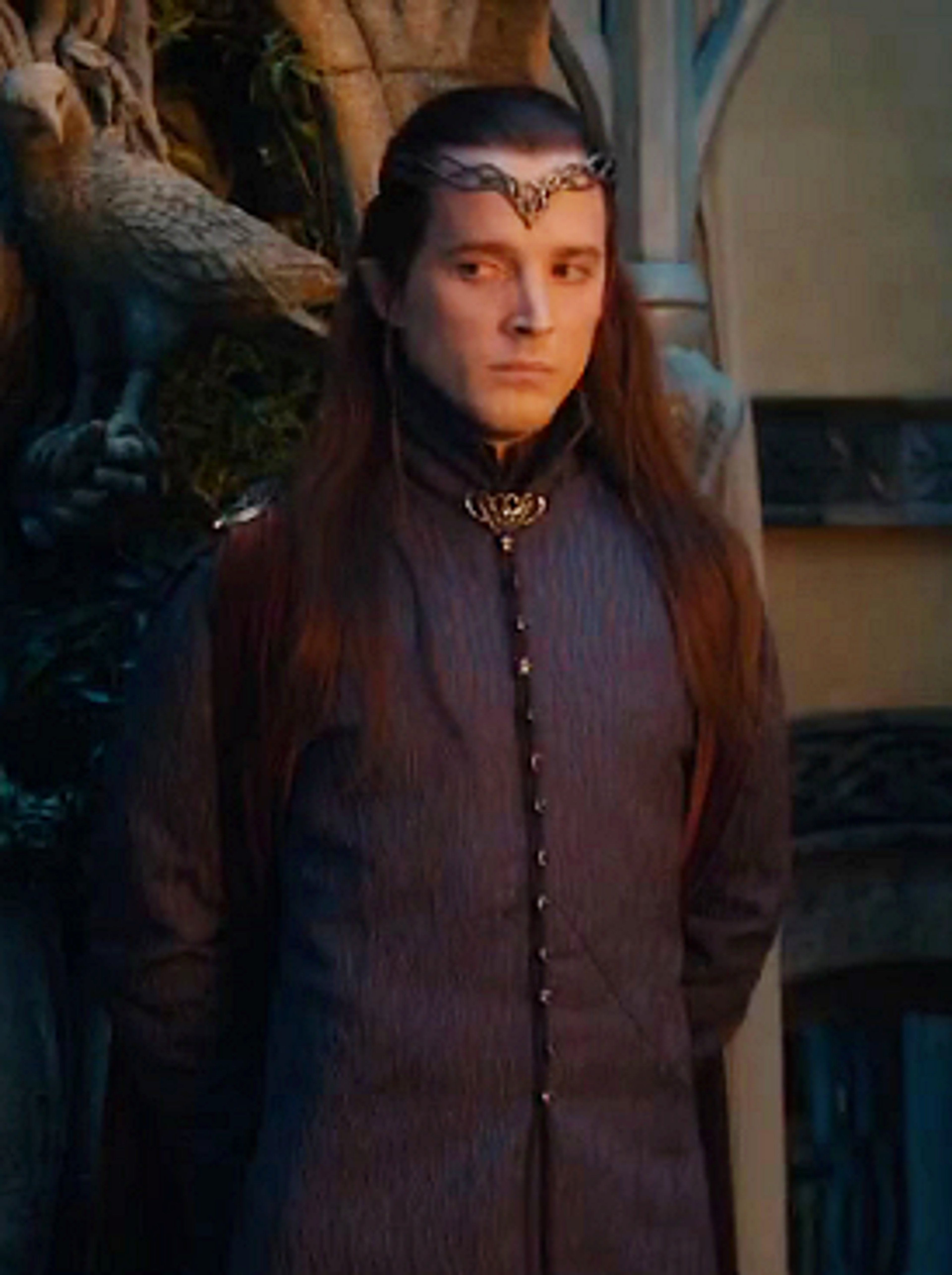 An elven character with long dark hair, pointed ears, and a serene expression, wearing a dark robe or cloak.