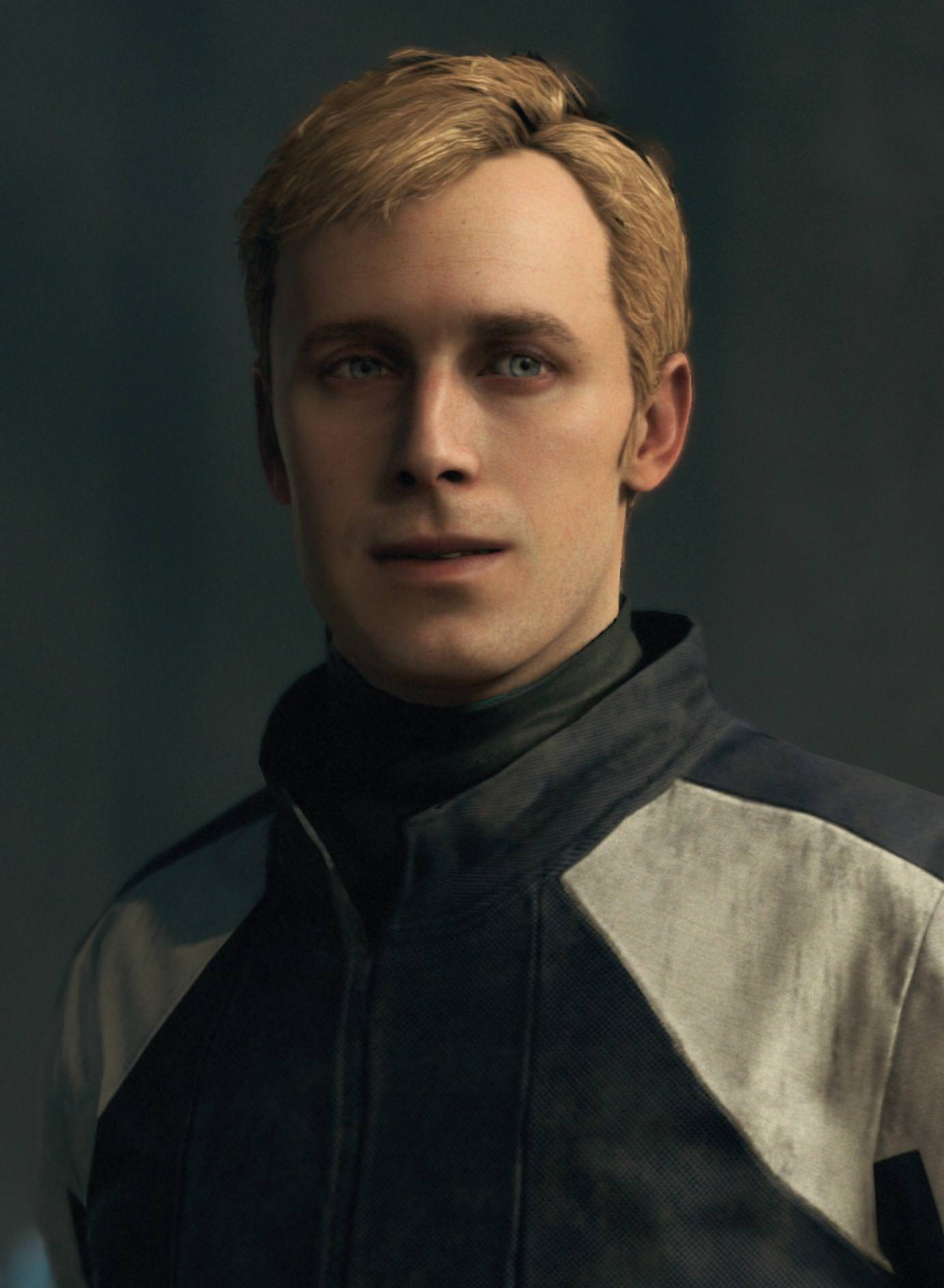 A portrait of a young man with blonde hair and blue eyes, wearing a dark jacket.