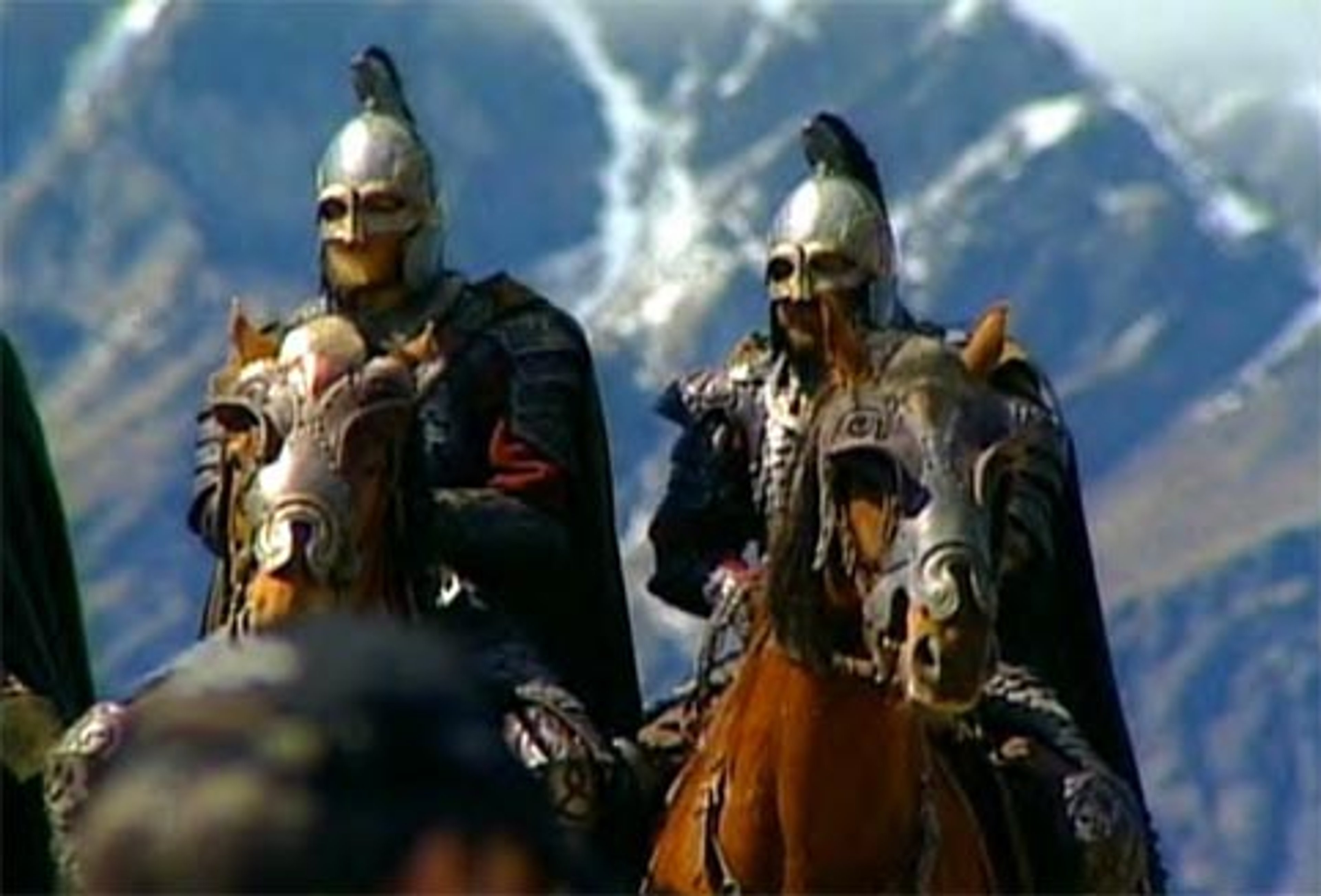 Two heavily armored Rohan Royal Guard soldiers on horseback in a snowy, mountainous landscape