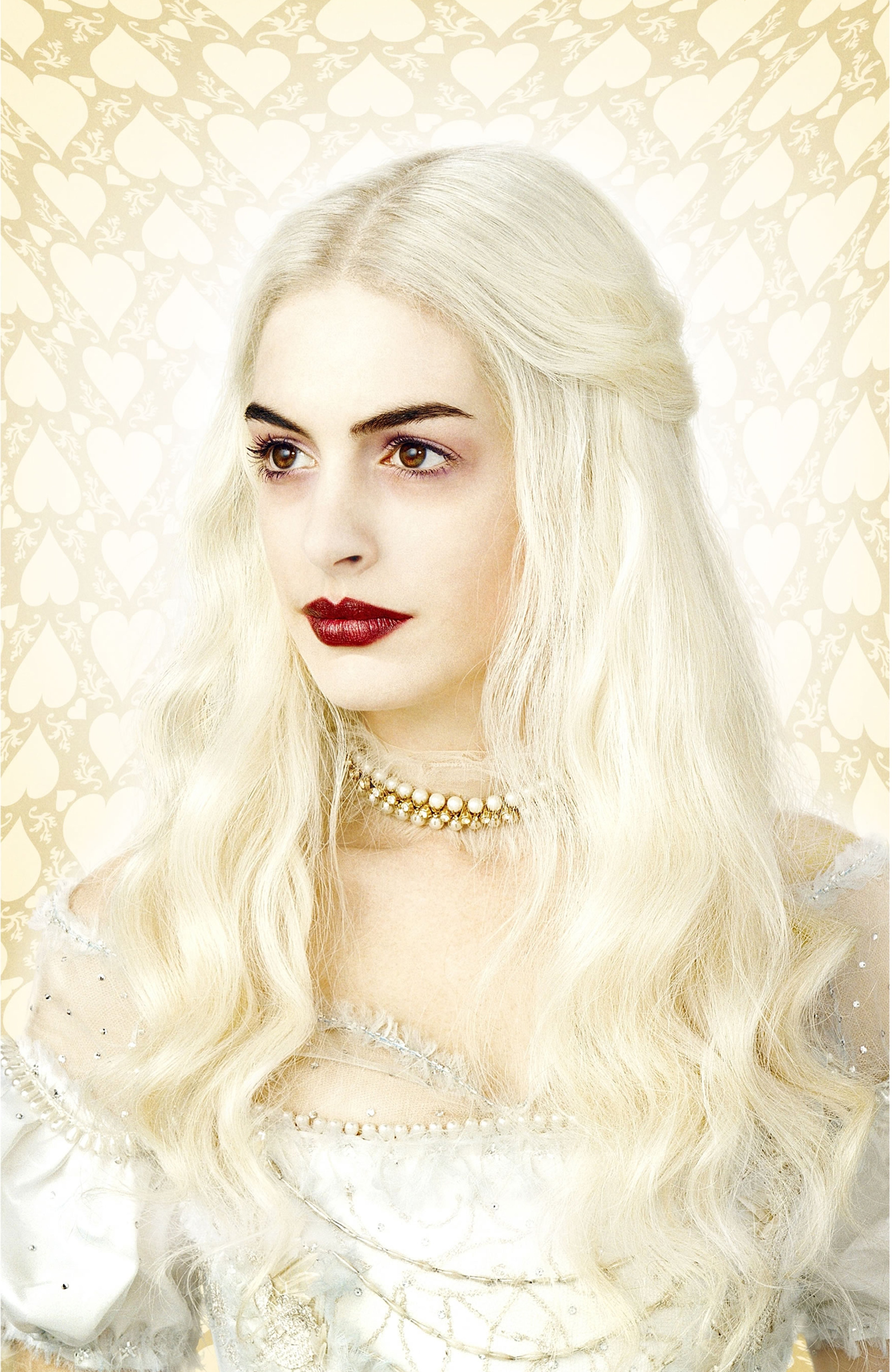 A woman with long blonde hair and red lips wearing a white lace dress, with a serene expression on her face.