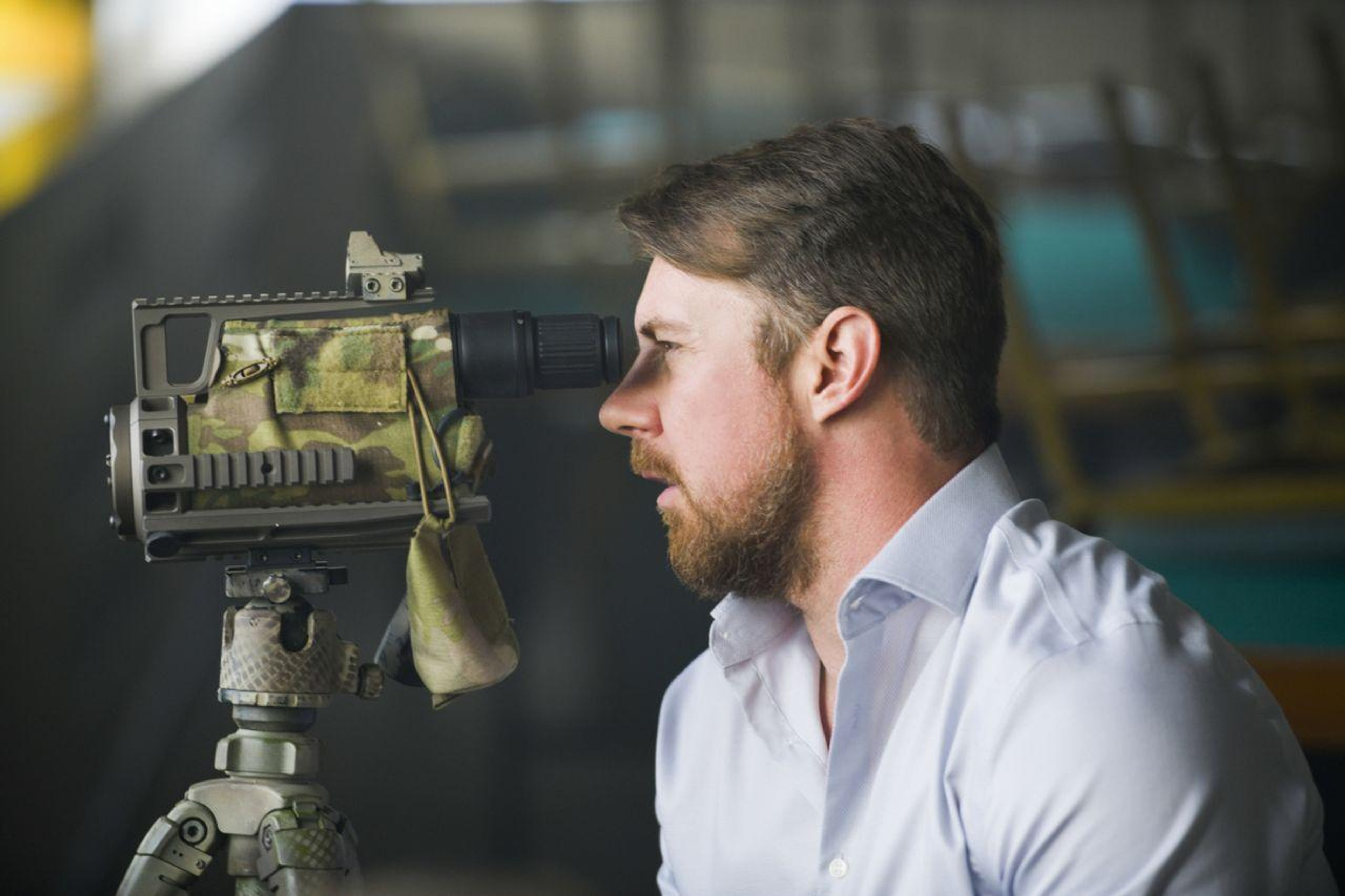 A man in a Navy SEAL uniform with a serious expression