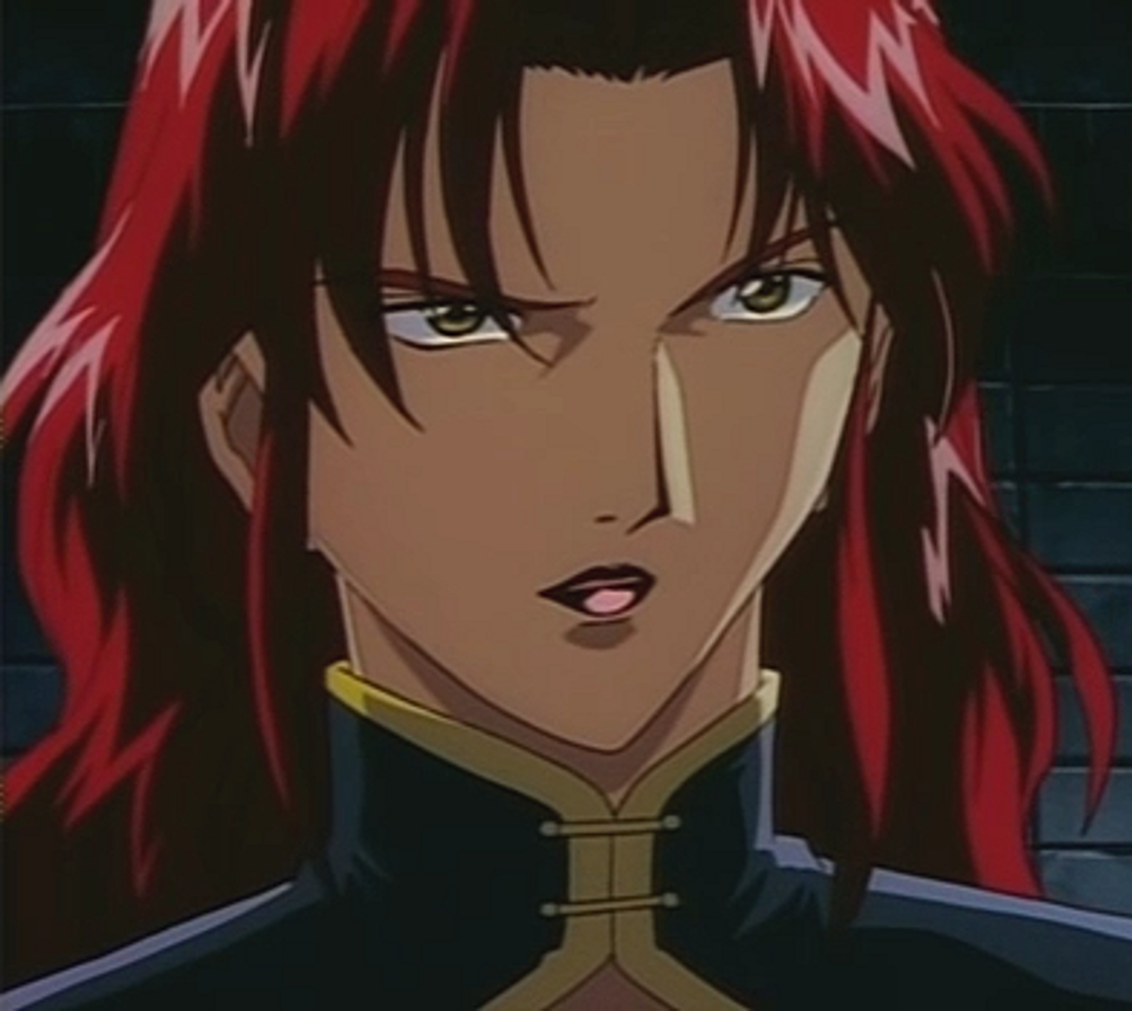 A woman with red hair wearing a dark business suit