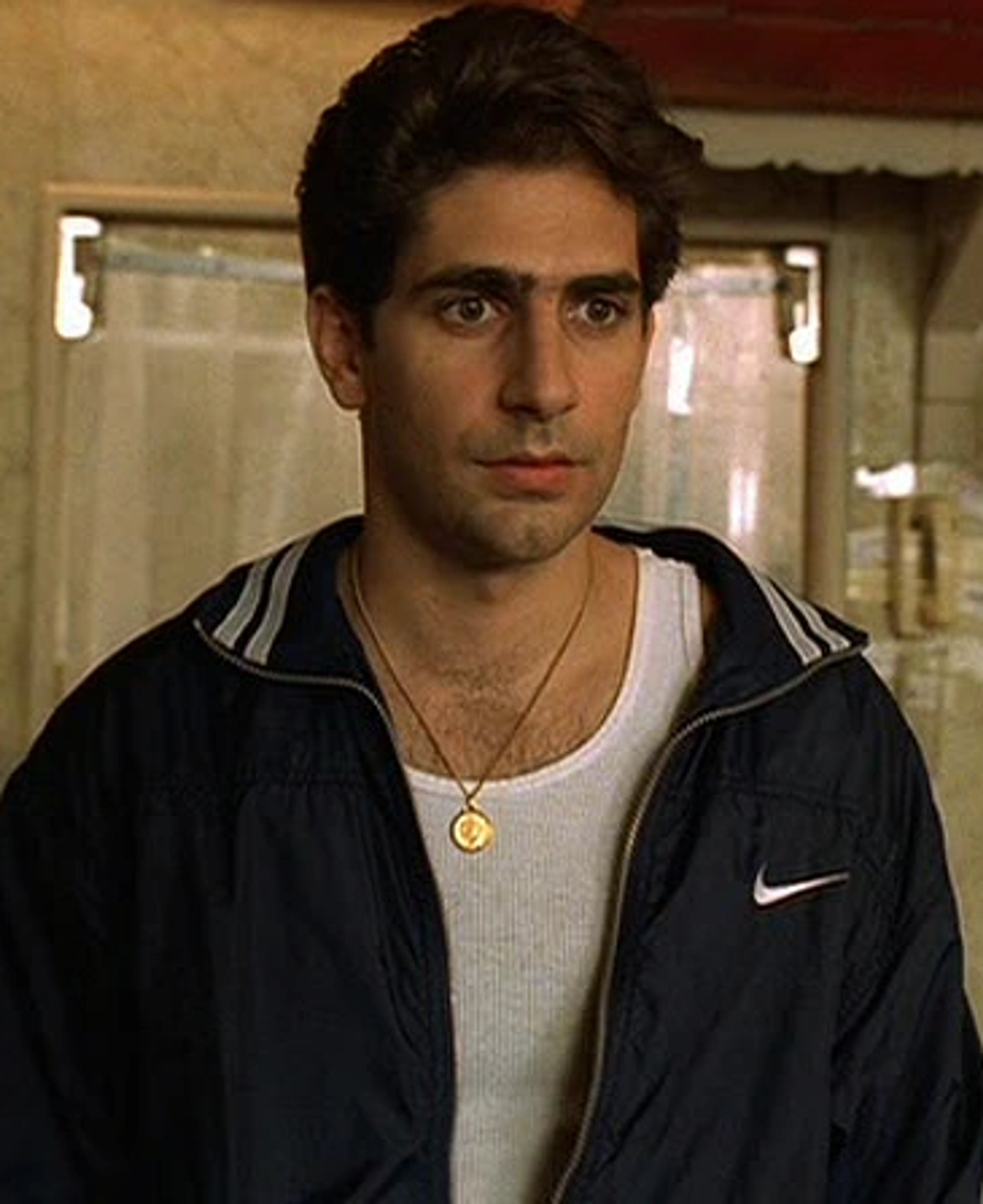A man with dark hair wearing a black jacket