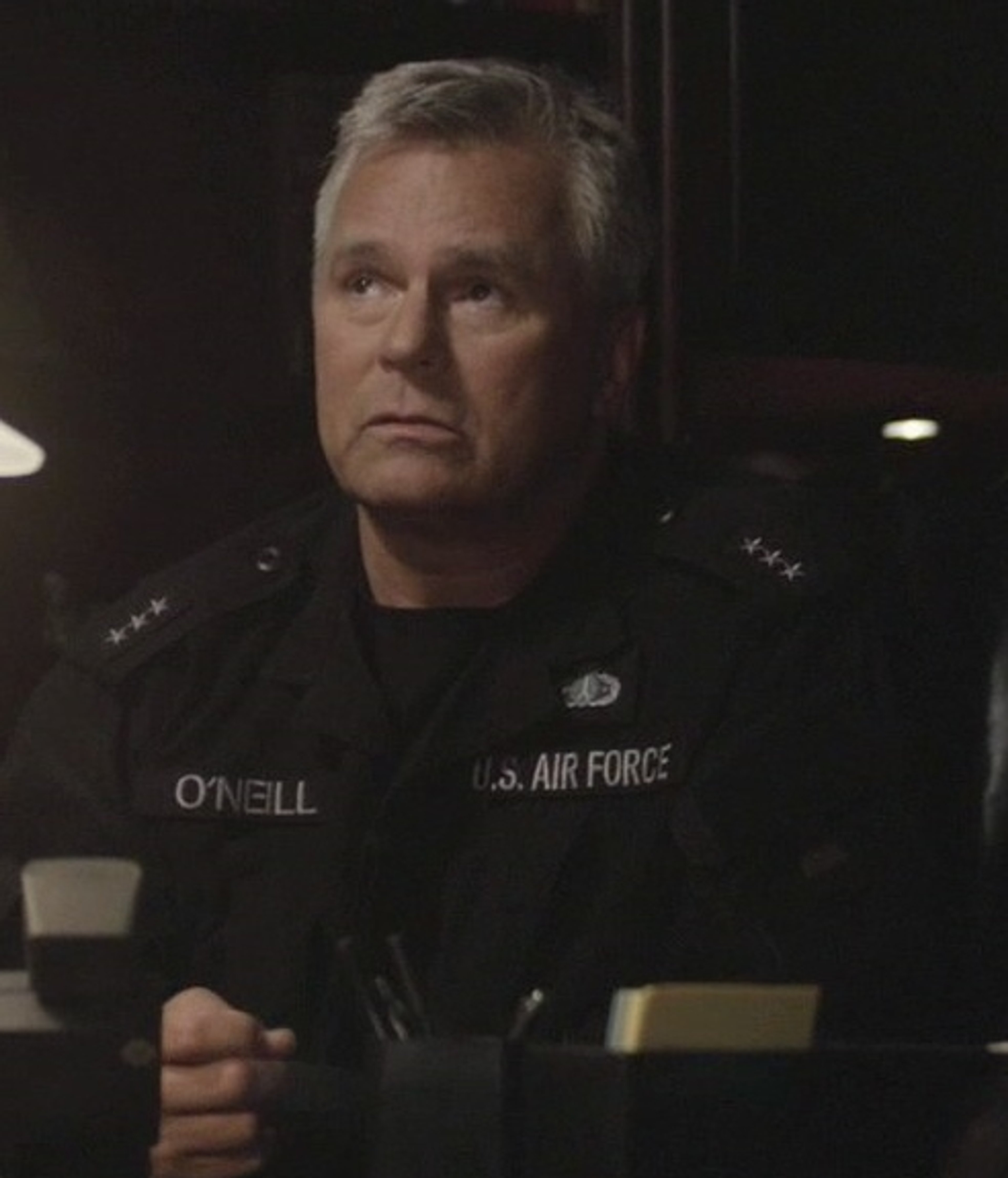 A United States Air Force colonel with short gray hair and a stern expression