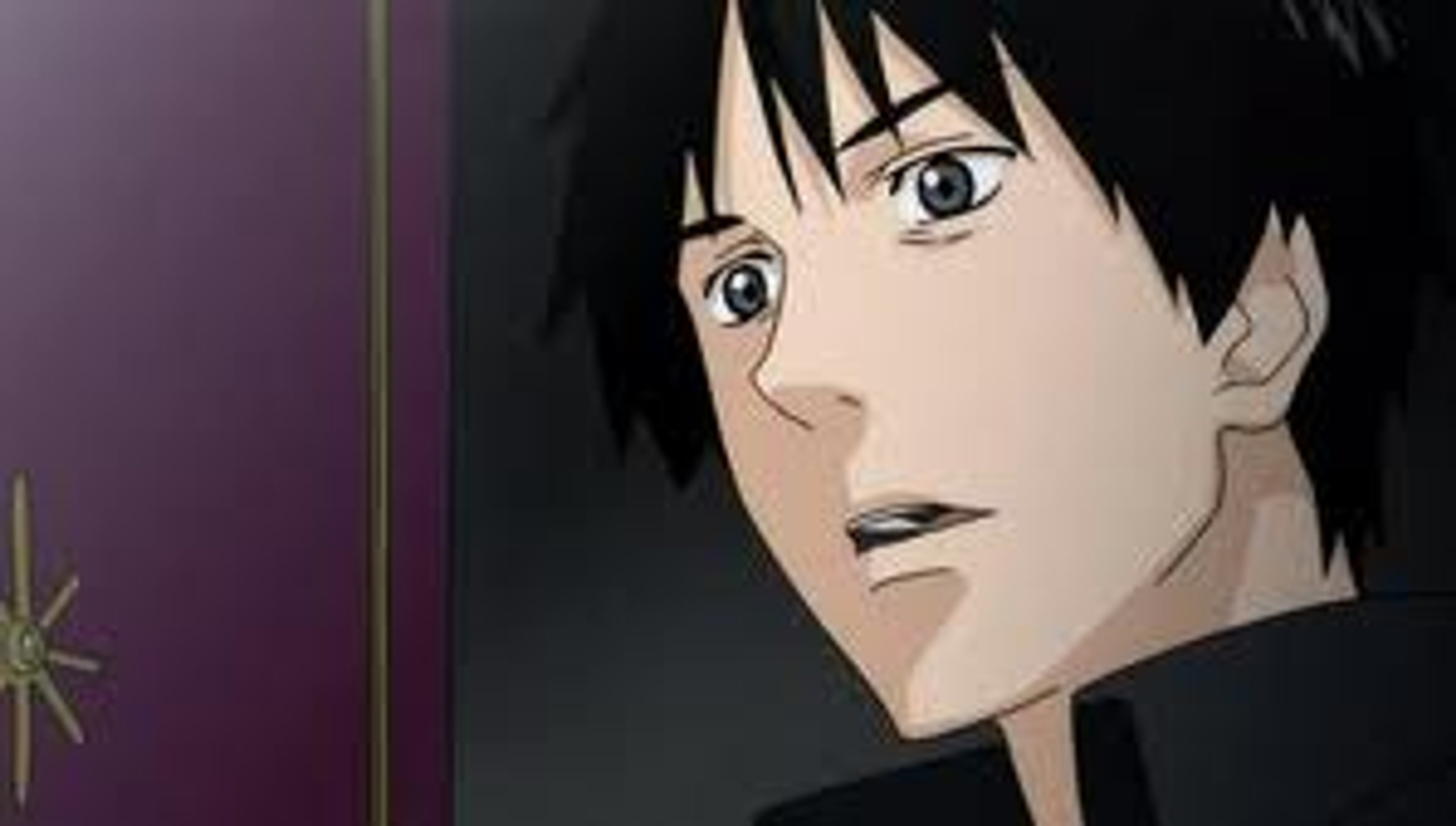 A young man with dark hair and a disheveled appearance, wearing casual clothing and a cap.