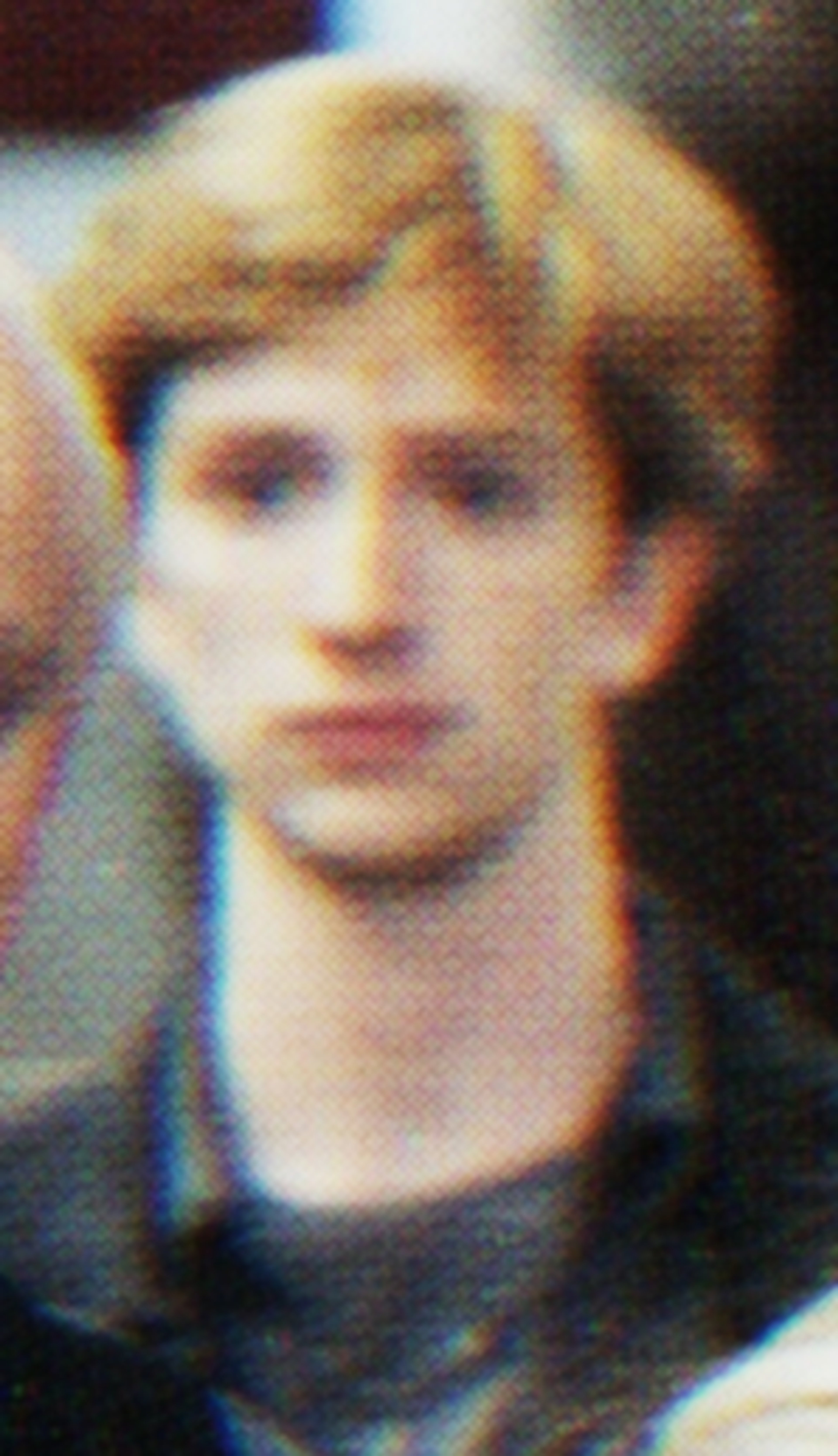 A young man with light brown hair and a friendly expression