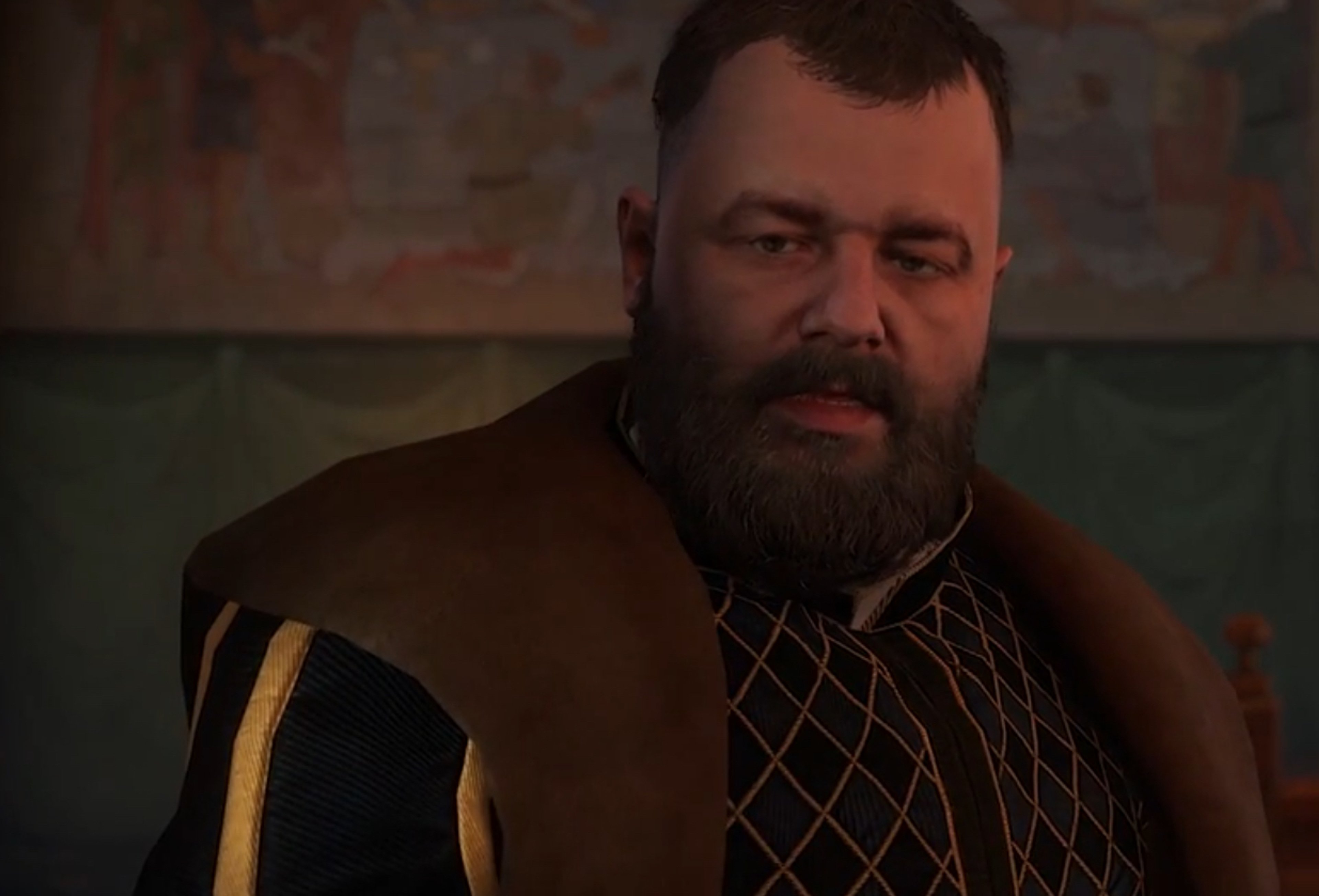 A middle-aged man with a beard wearing a brown coat, looking stern and authoritative.