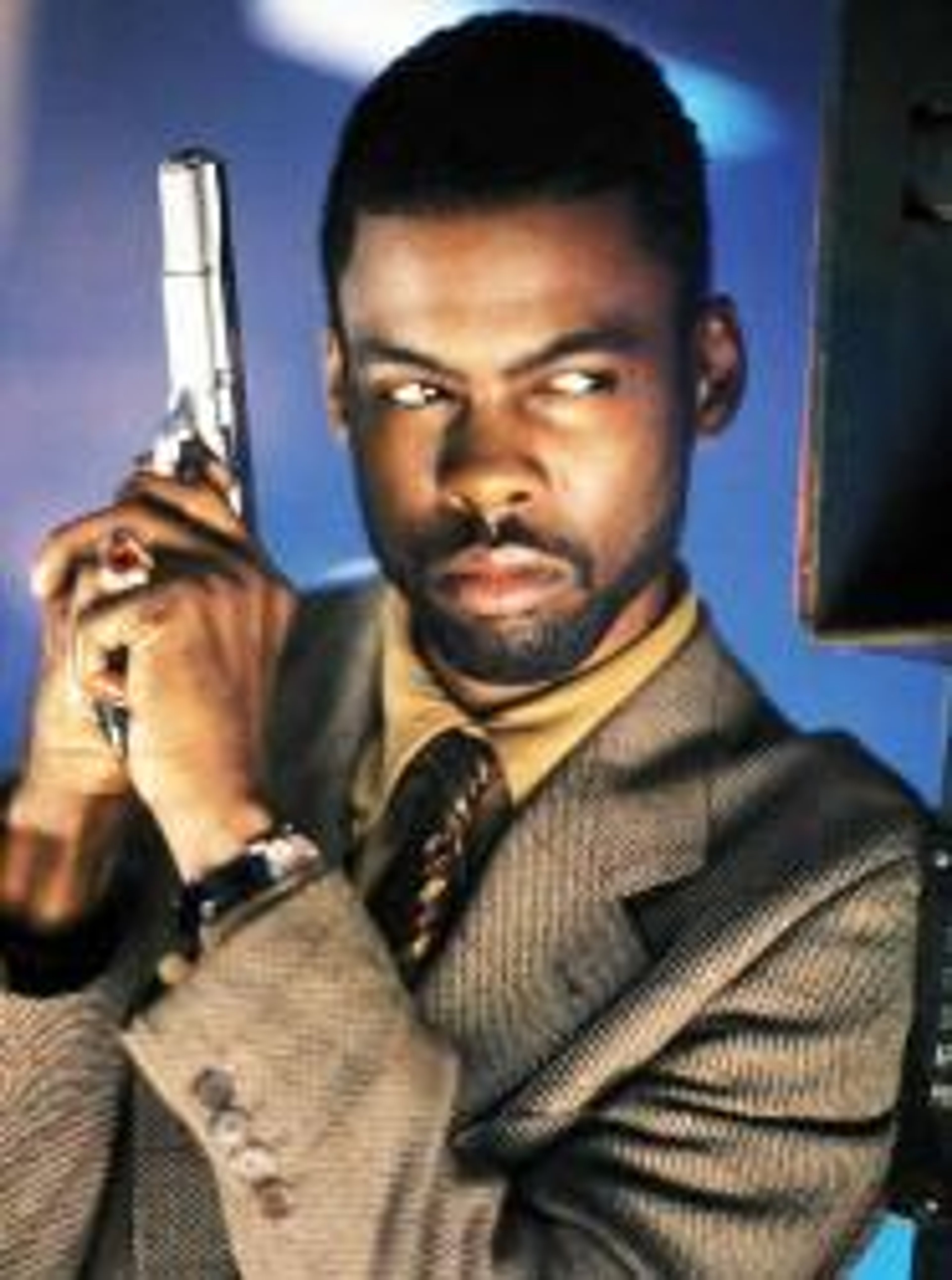 A man in a suit holding a gun