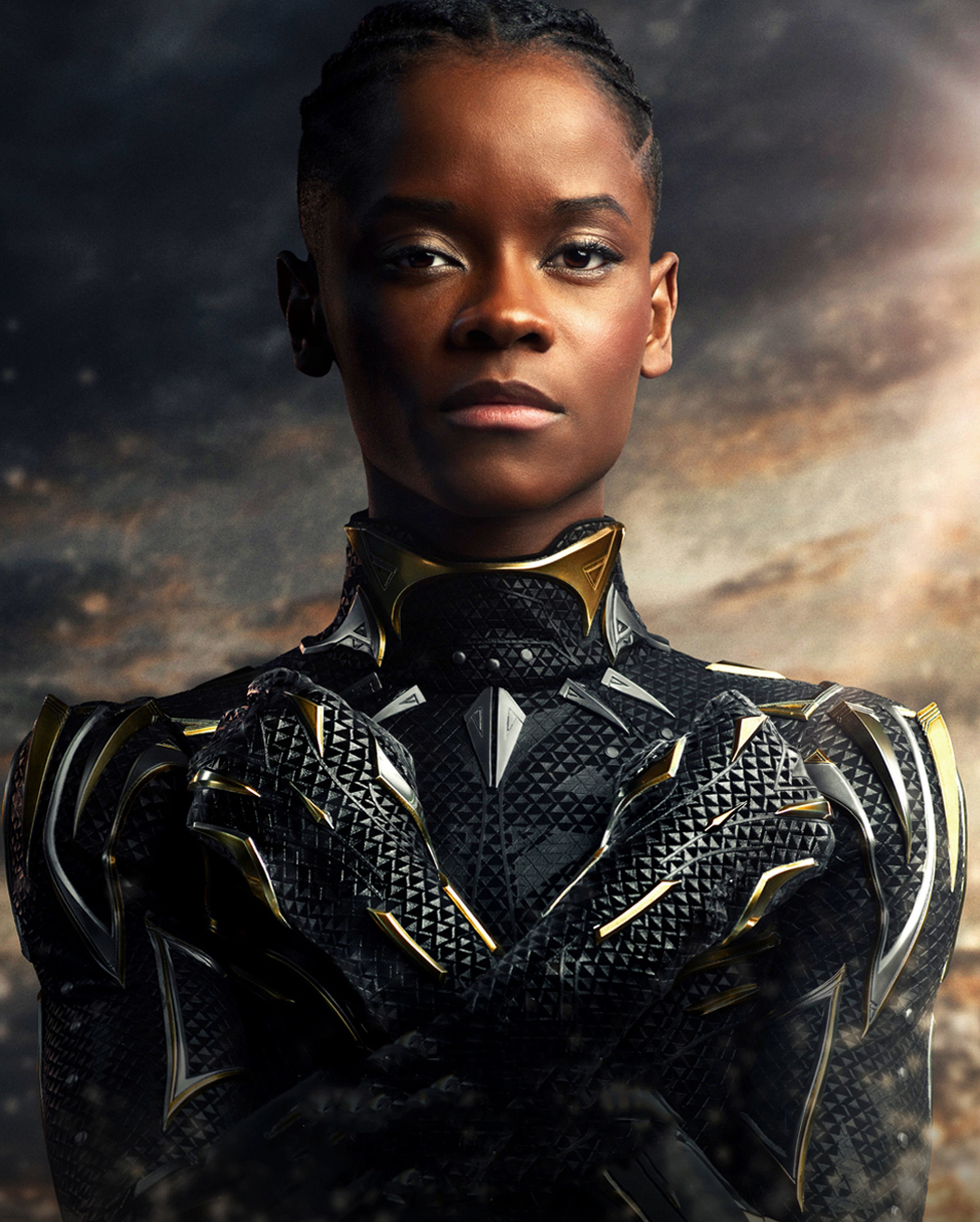 A young Black woman in a high-tech, futuristic costume standing in a heroic pose.