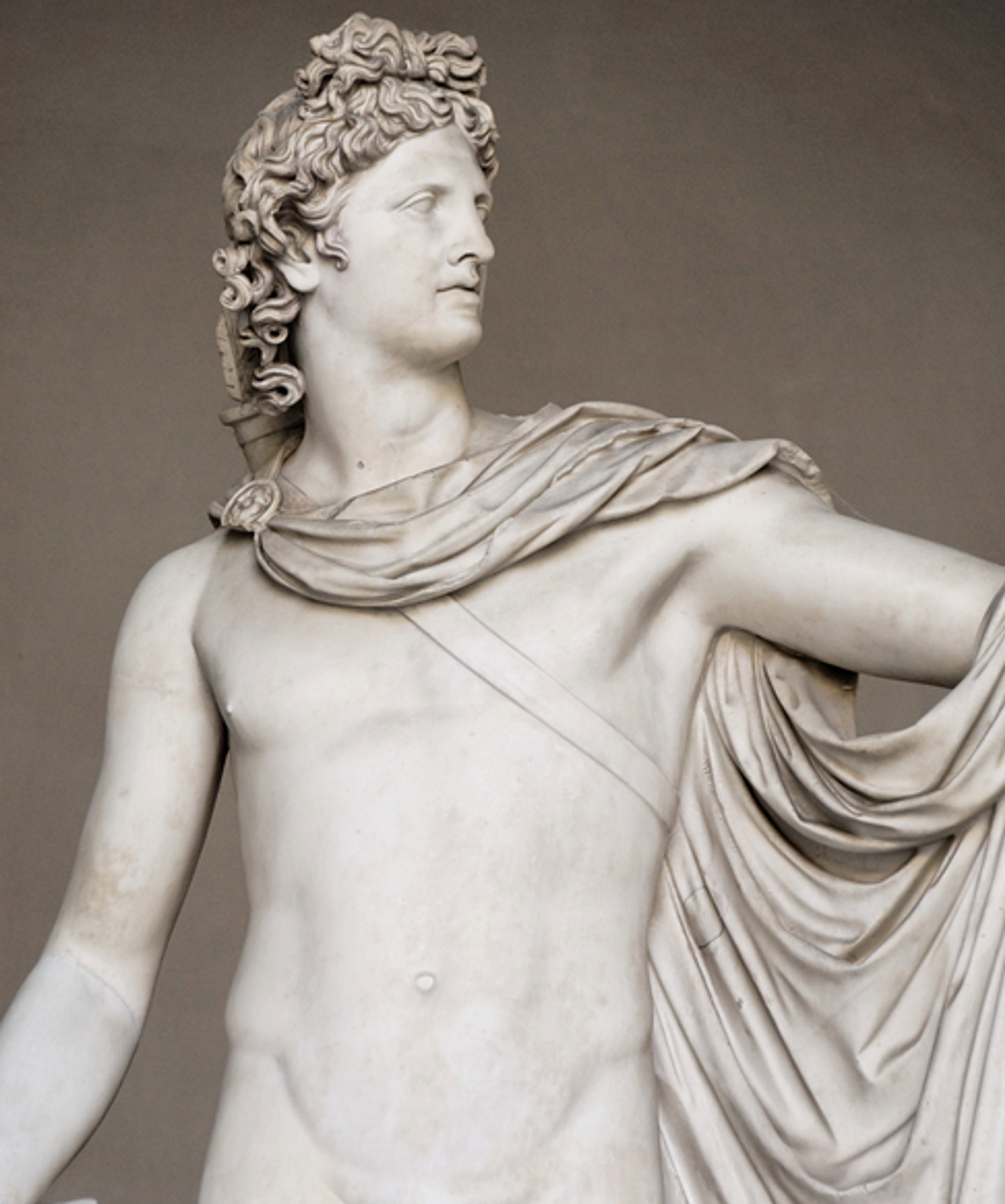 A sculpture of the Greek god Apollo, depicted as a young, muscular, and handsome man with curly hair and a laurel wreath.