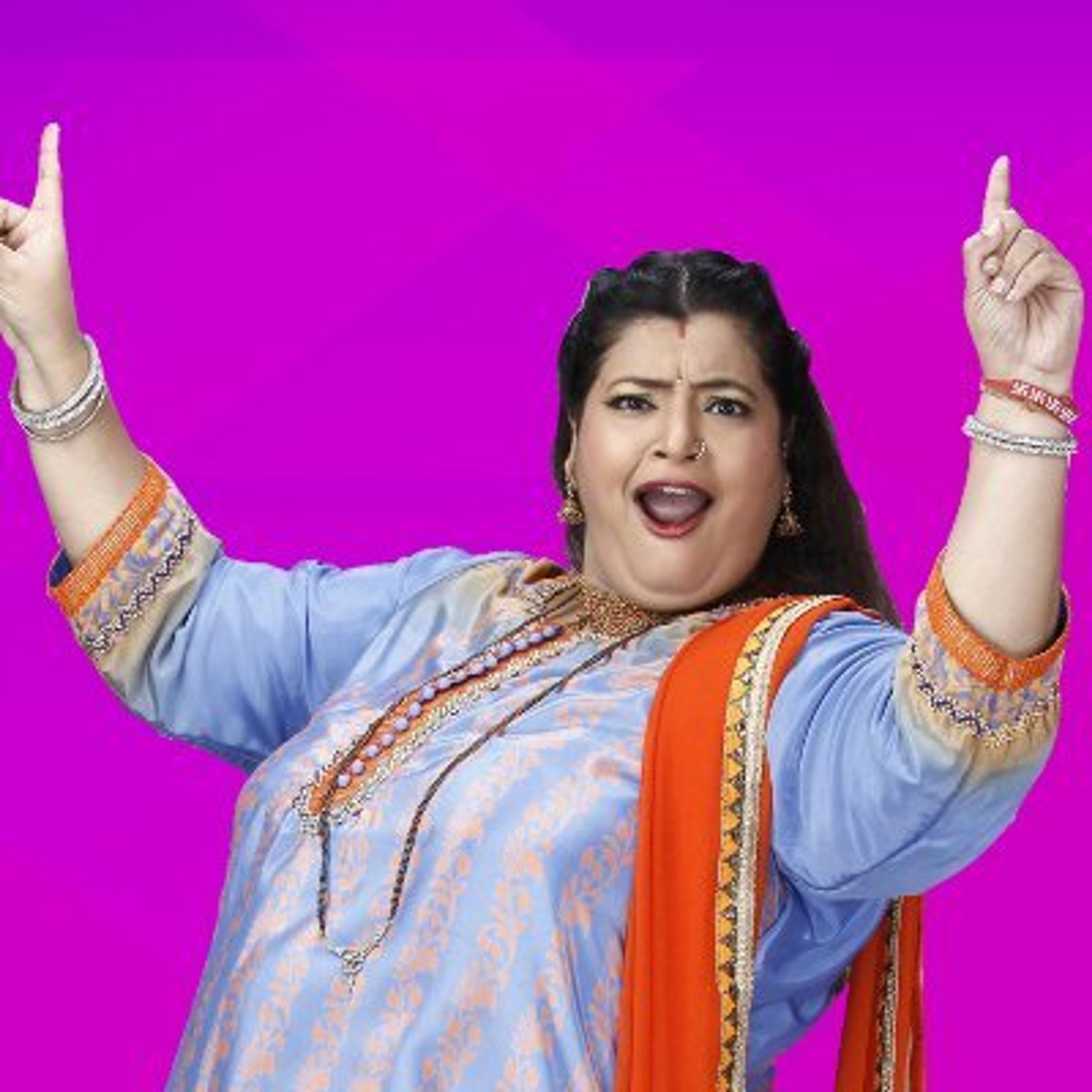 A confident, middle-aged woman in a colorful outfit gesturing with her arms raised against a pink background.