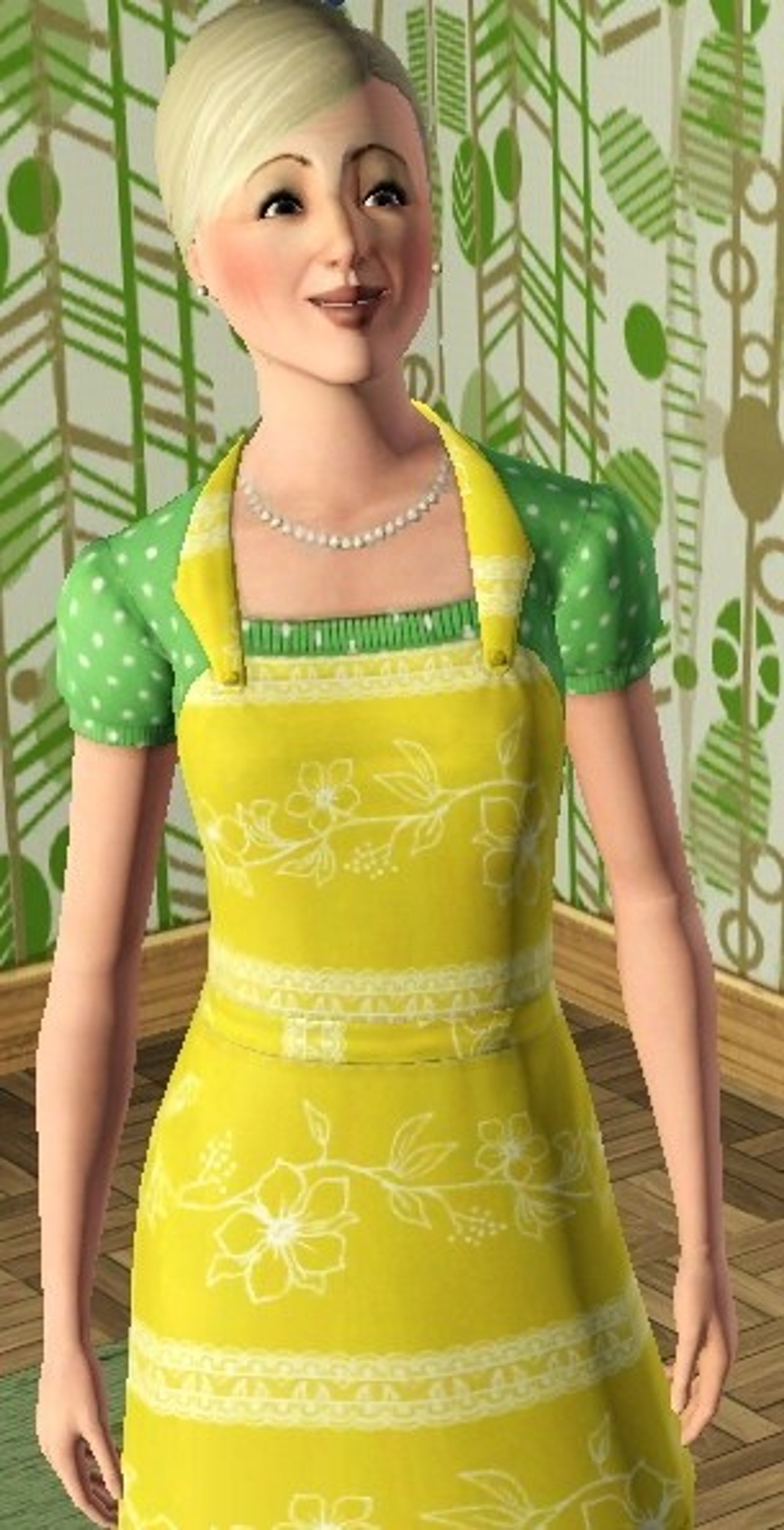 A smiling blonde woman wearing a yellow and green polka dot dress