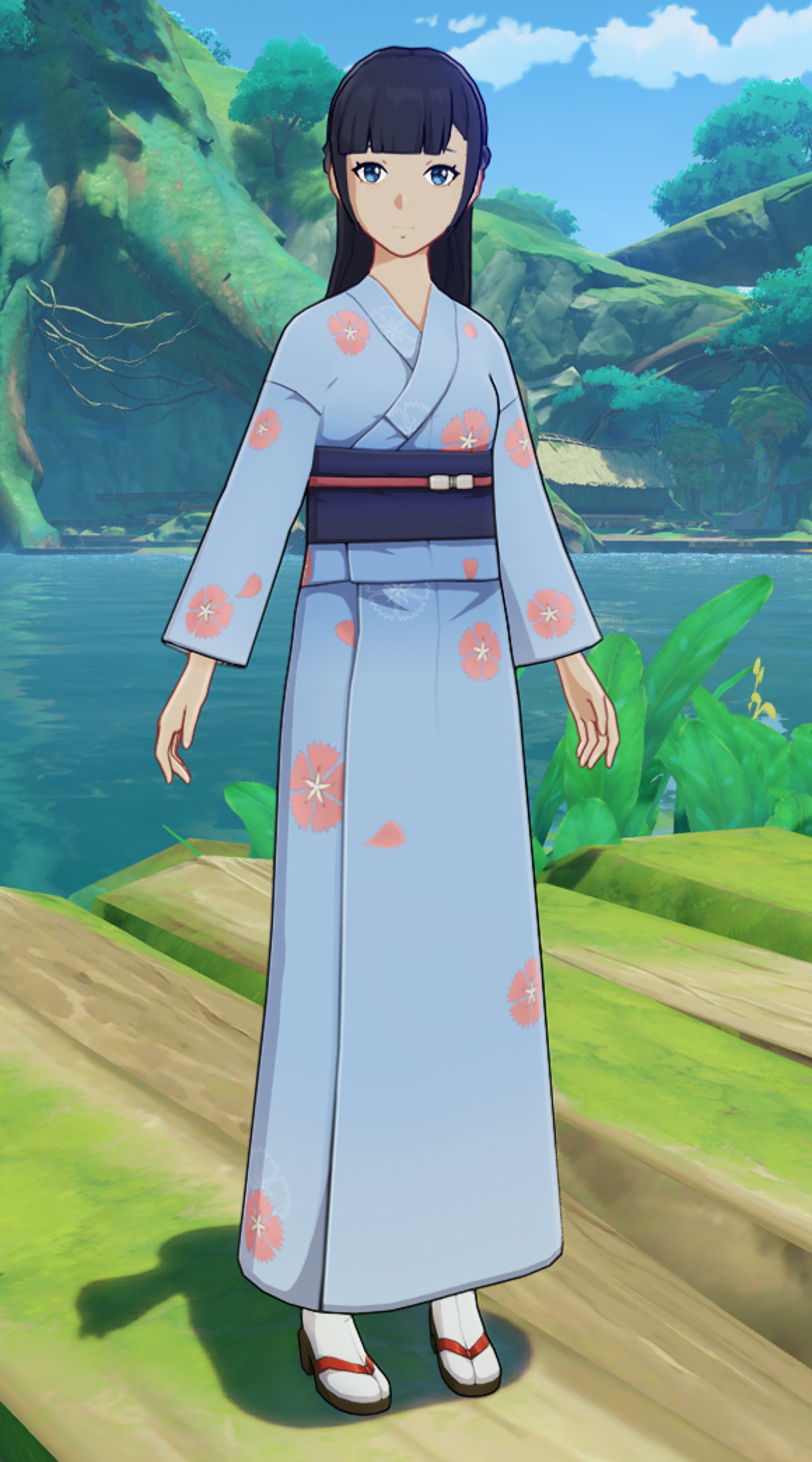A young woman in a light blue kimono-style dress standing in a natural outdoor setting