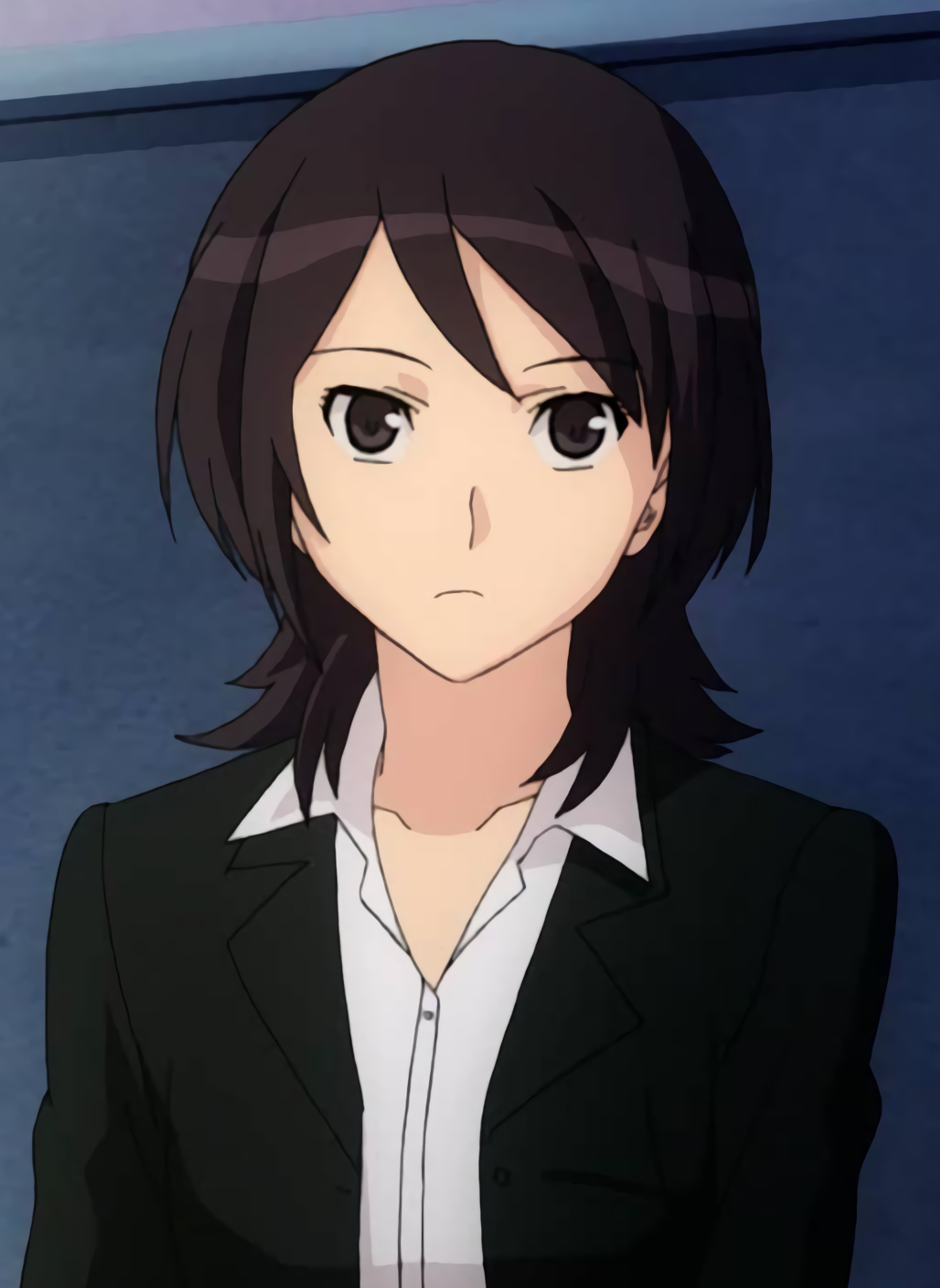 A young woman in a black suit with a serious expression