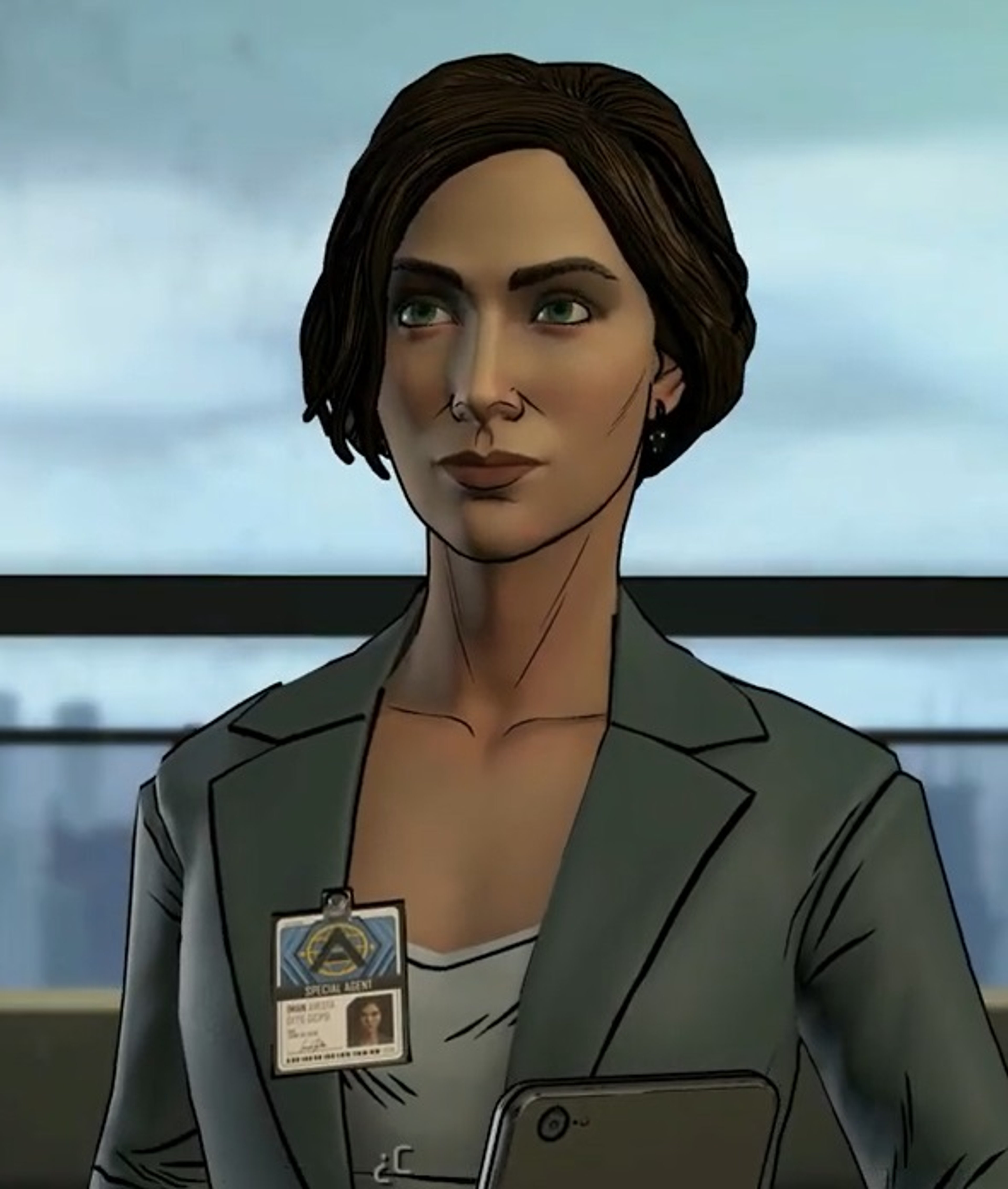 A woman in a gray blazer with a government ID badge