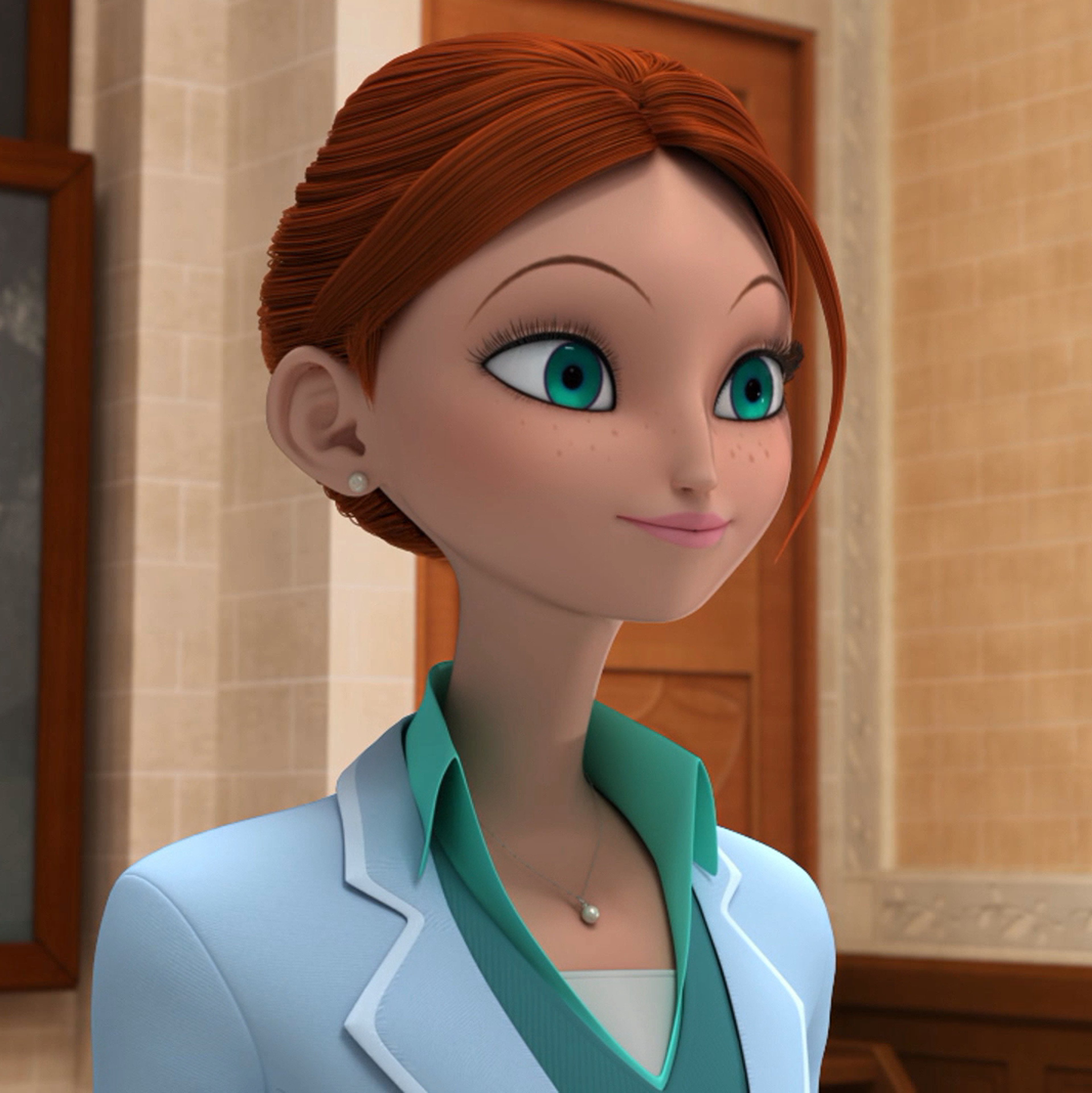 A woman with ginger hair in a high bun, wearing a light blue blouse