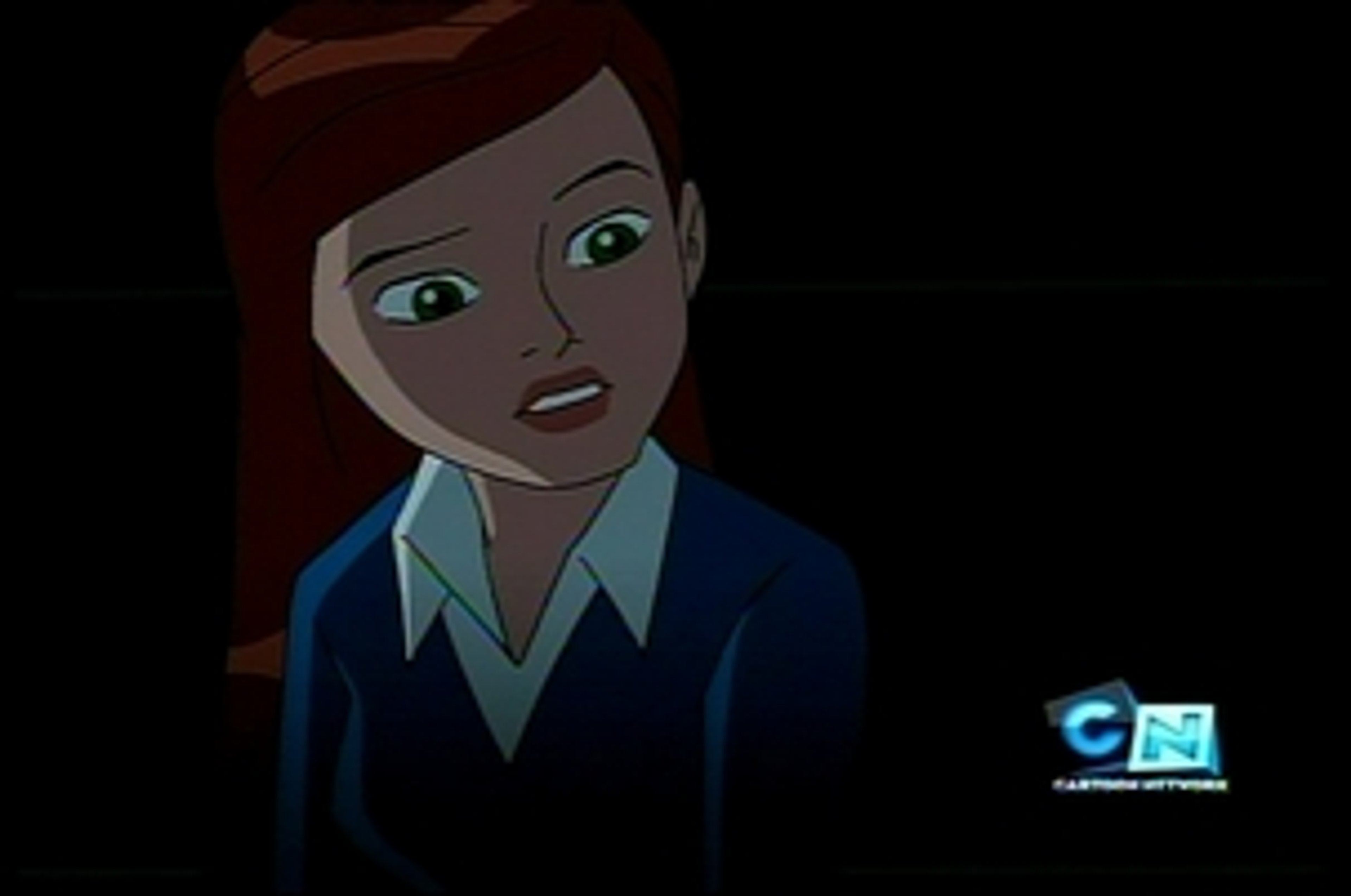 A young woman with red hair and green eyes wearing a blue shirt