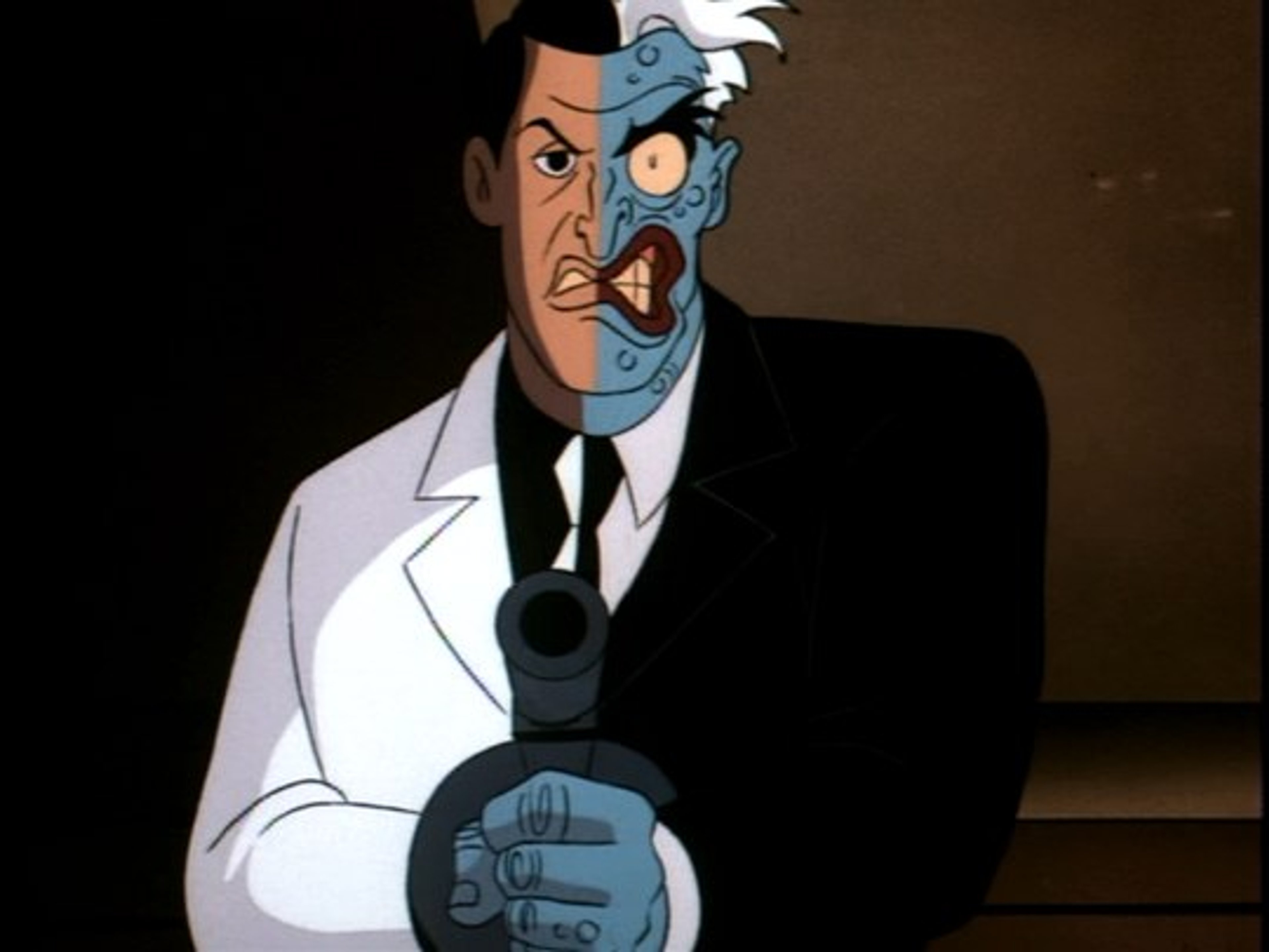 A character with a split, scarred face wearing a dark suit