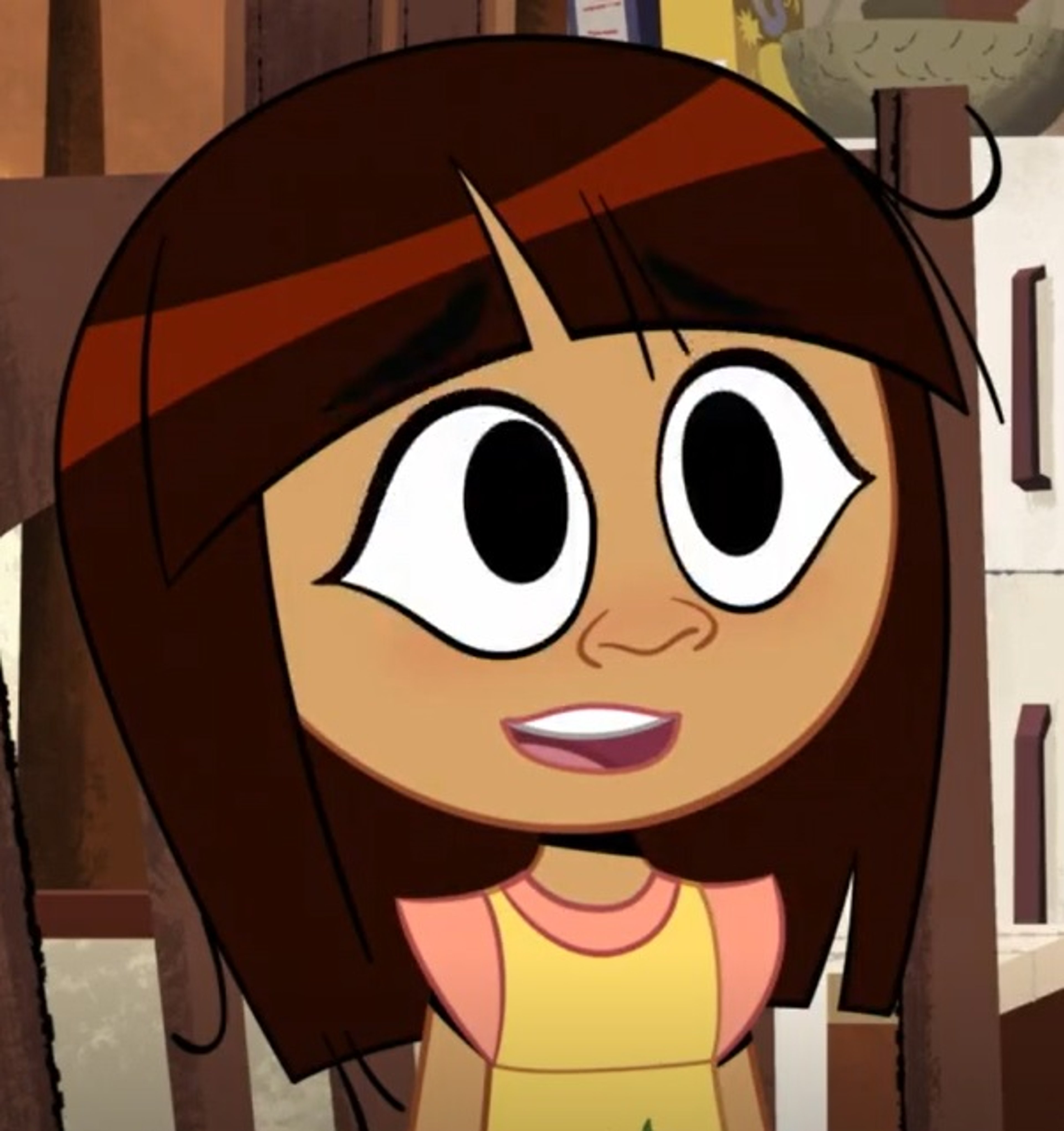 A cartoon character of a young female with brown hair and a pink and yellow outfit, with a friendly expression.