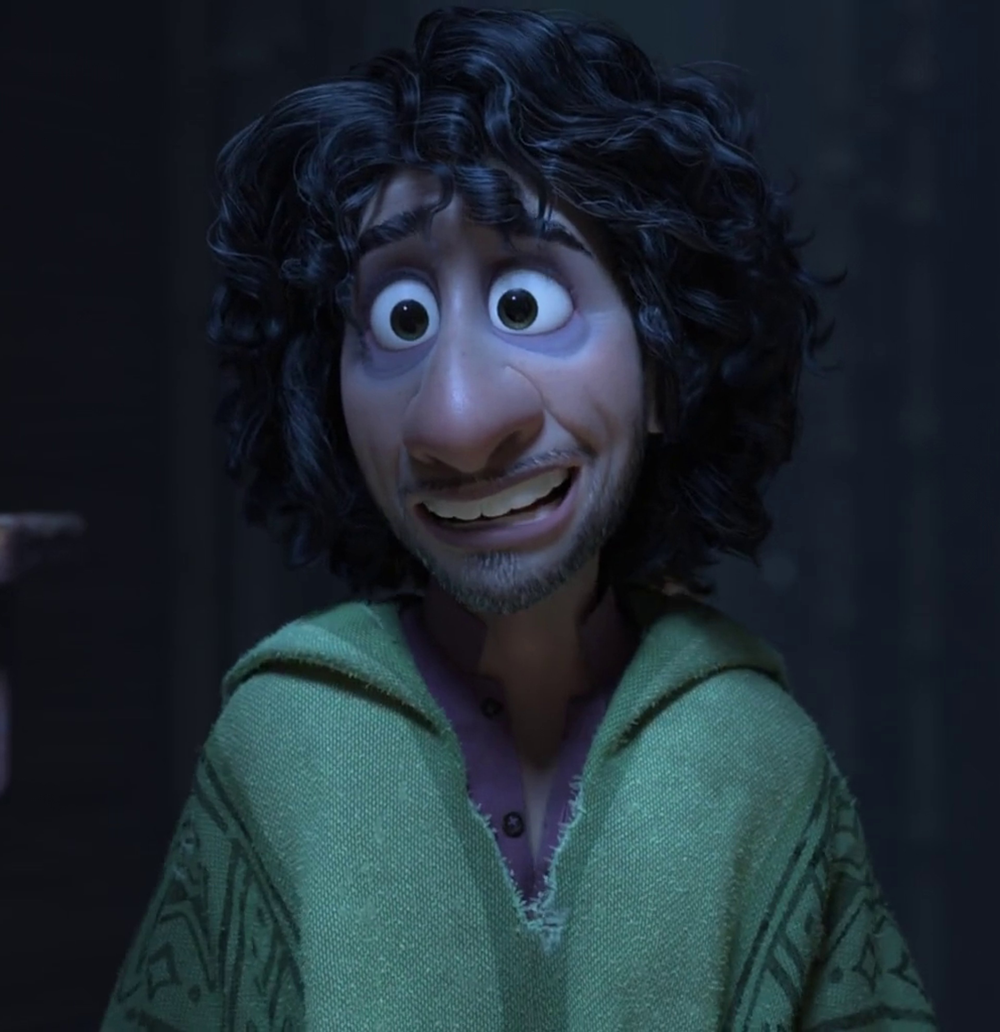 An animated character with large eyes, a wide smile, and curly dark hair wearing a green sweater or jacket.