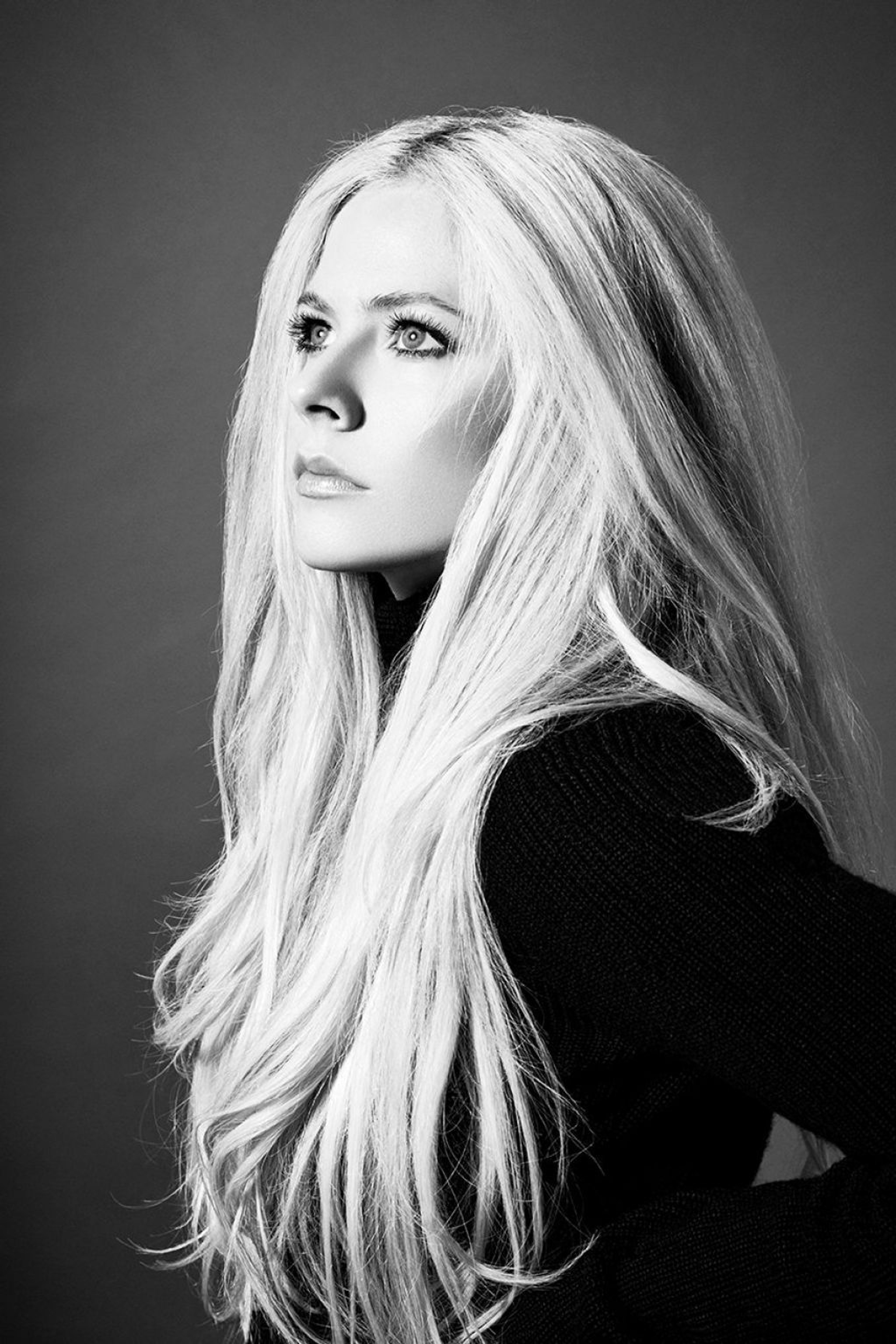 A black and white portrait of a young woman with long, blonde hair