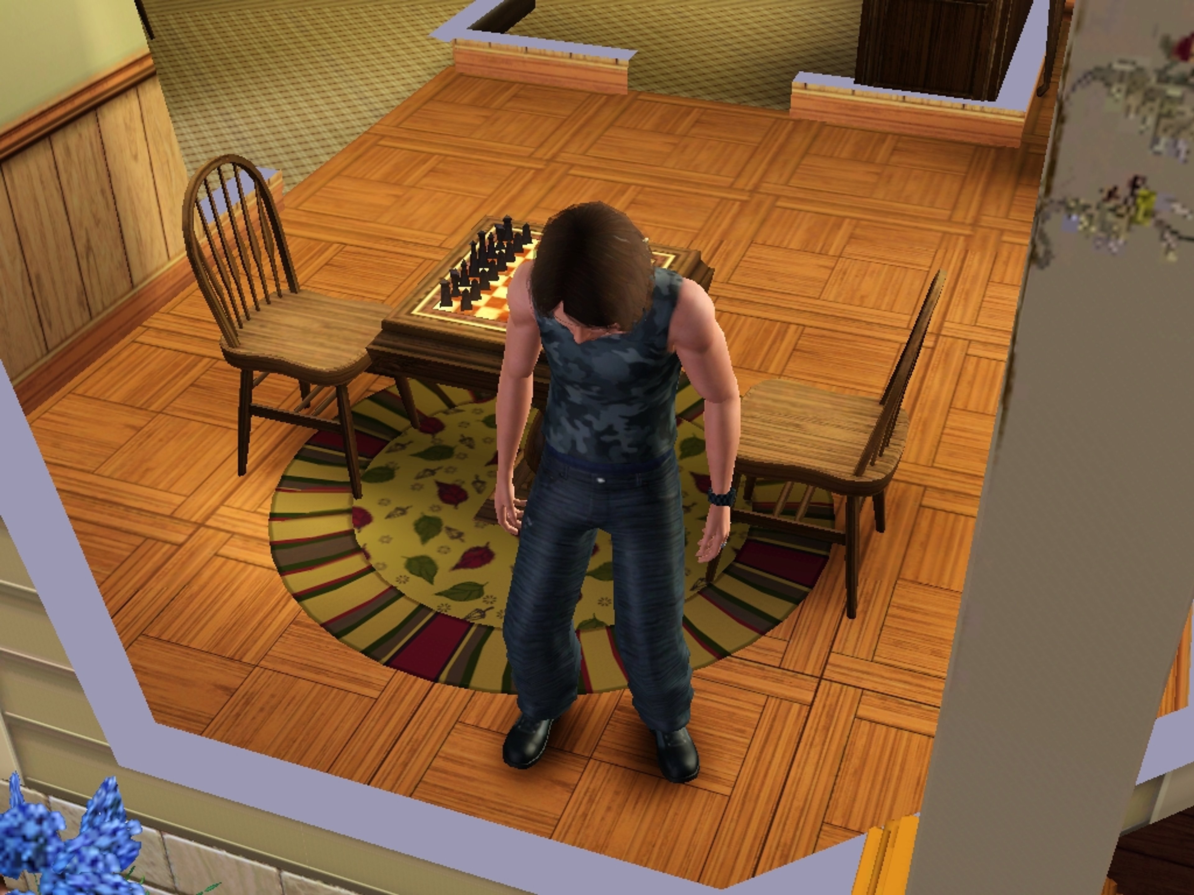 A young man with short dark hair standing in a room with wooden floors and furniture.