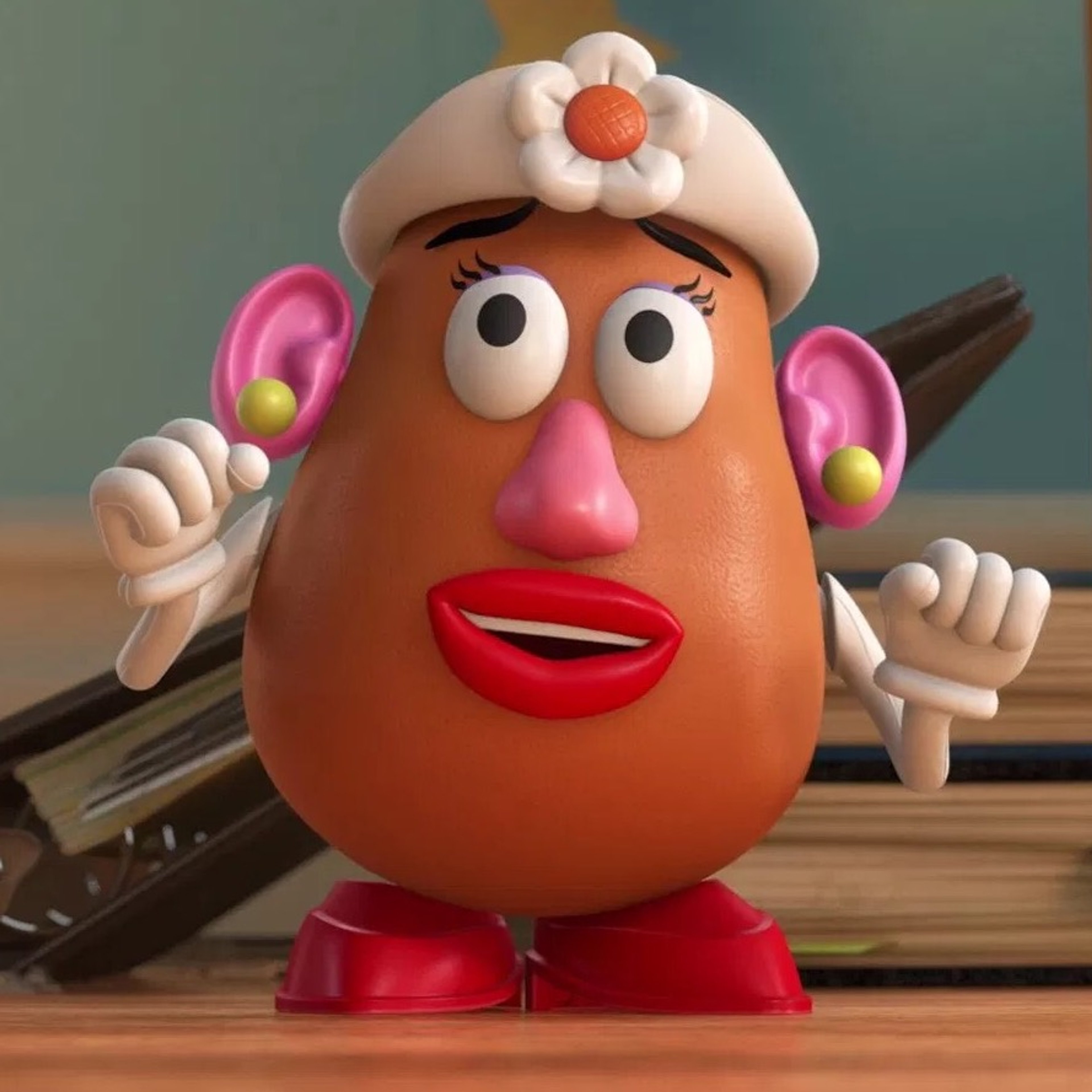 A plastic toy figure of Mrs. Potato Head, a motherly, feminine character with a round body, glasses, and detachable parts.