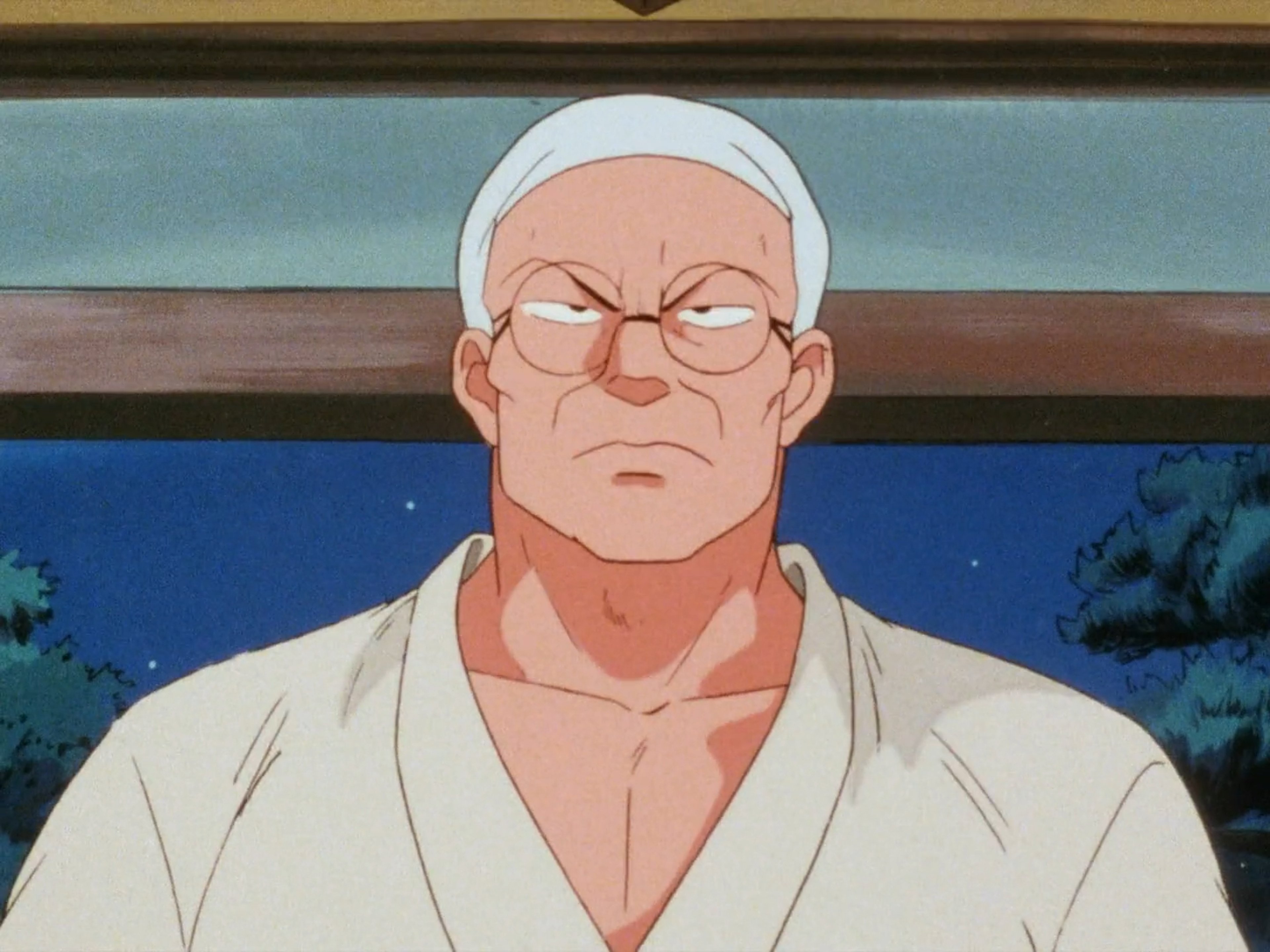 A middle-aged man in a martial arts gi with a stern expression