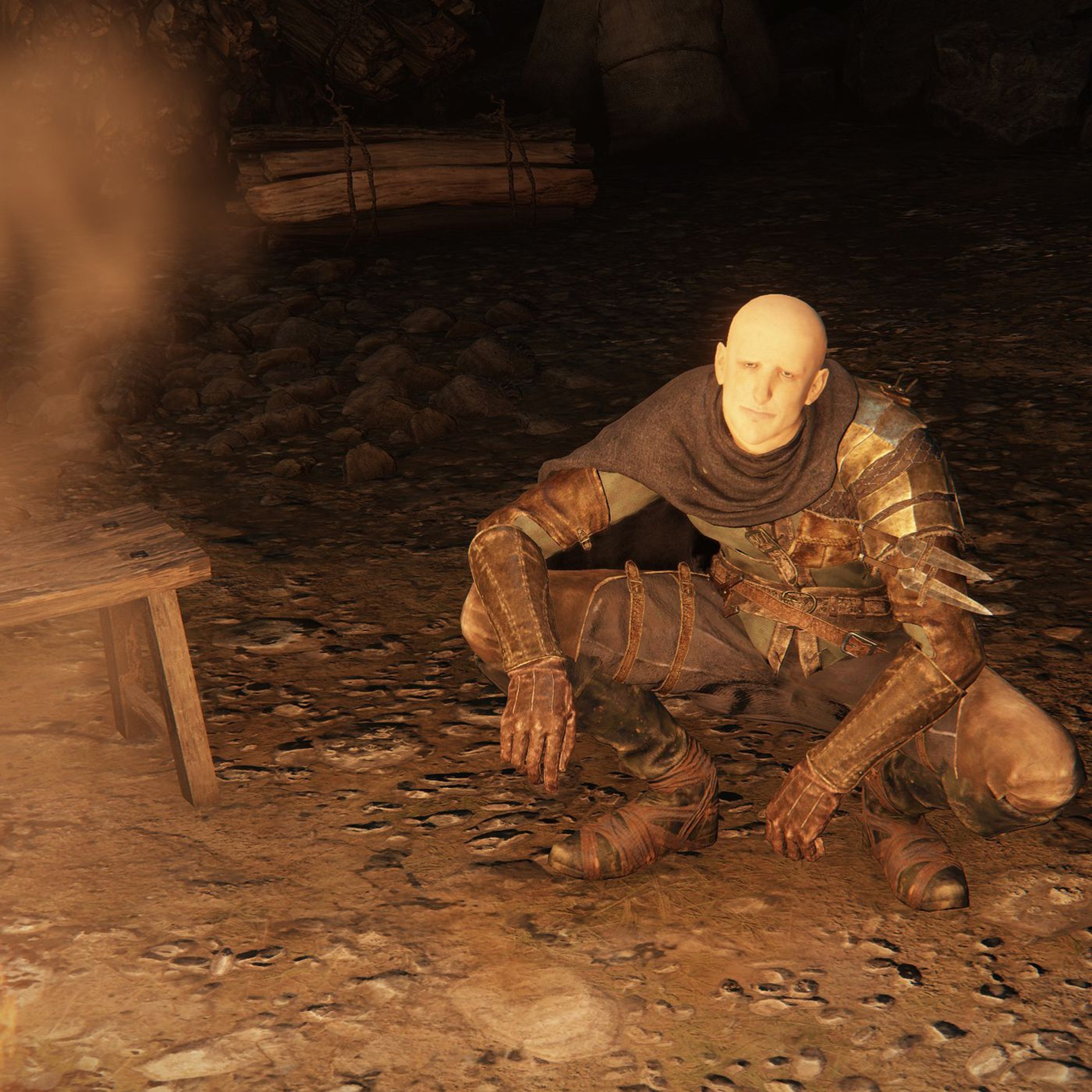 An elderly, disheveled man crouched on the ground in a dark, gritty environment