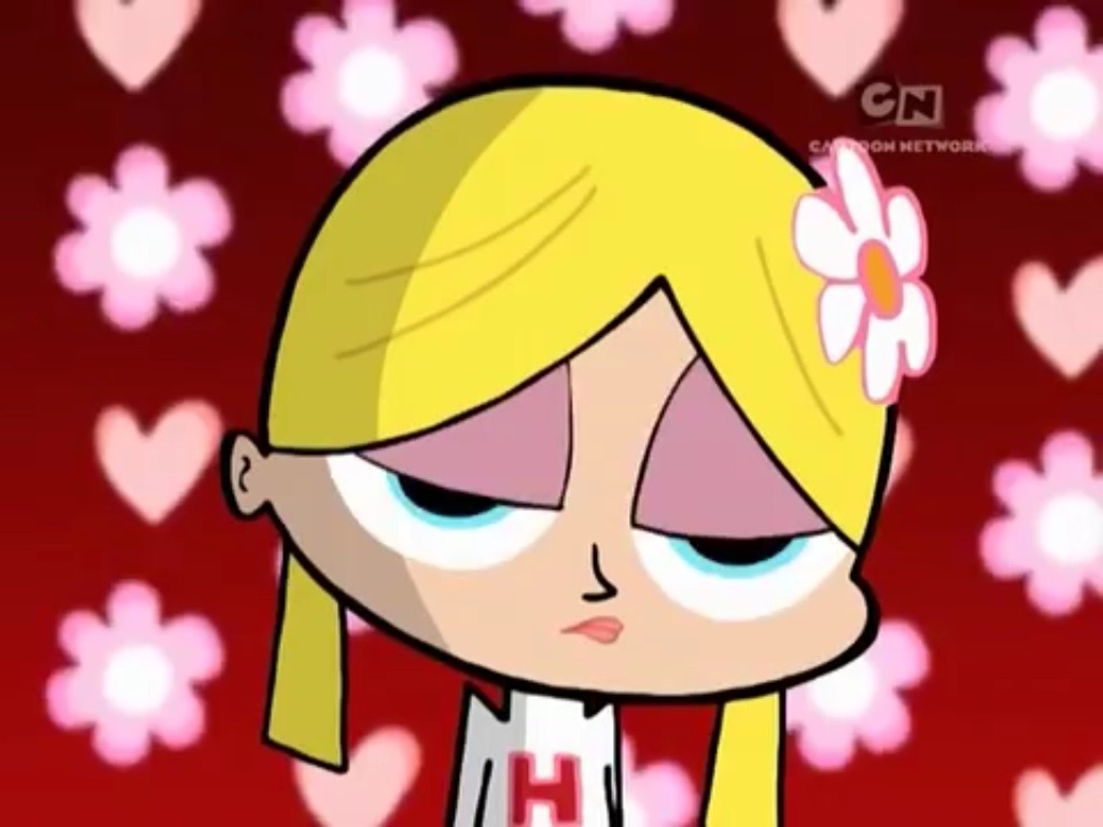 A cartoon image of a blonde, cheerleader-style female character with a confident, slightly arrogant expression.