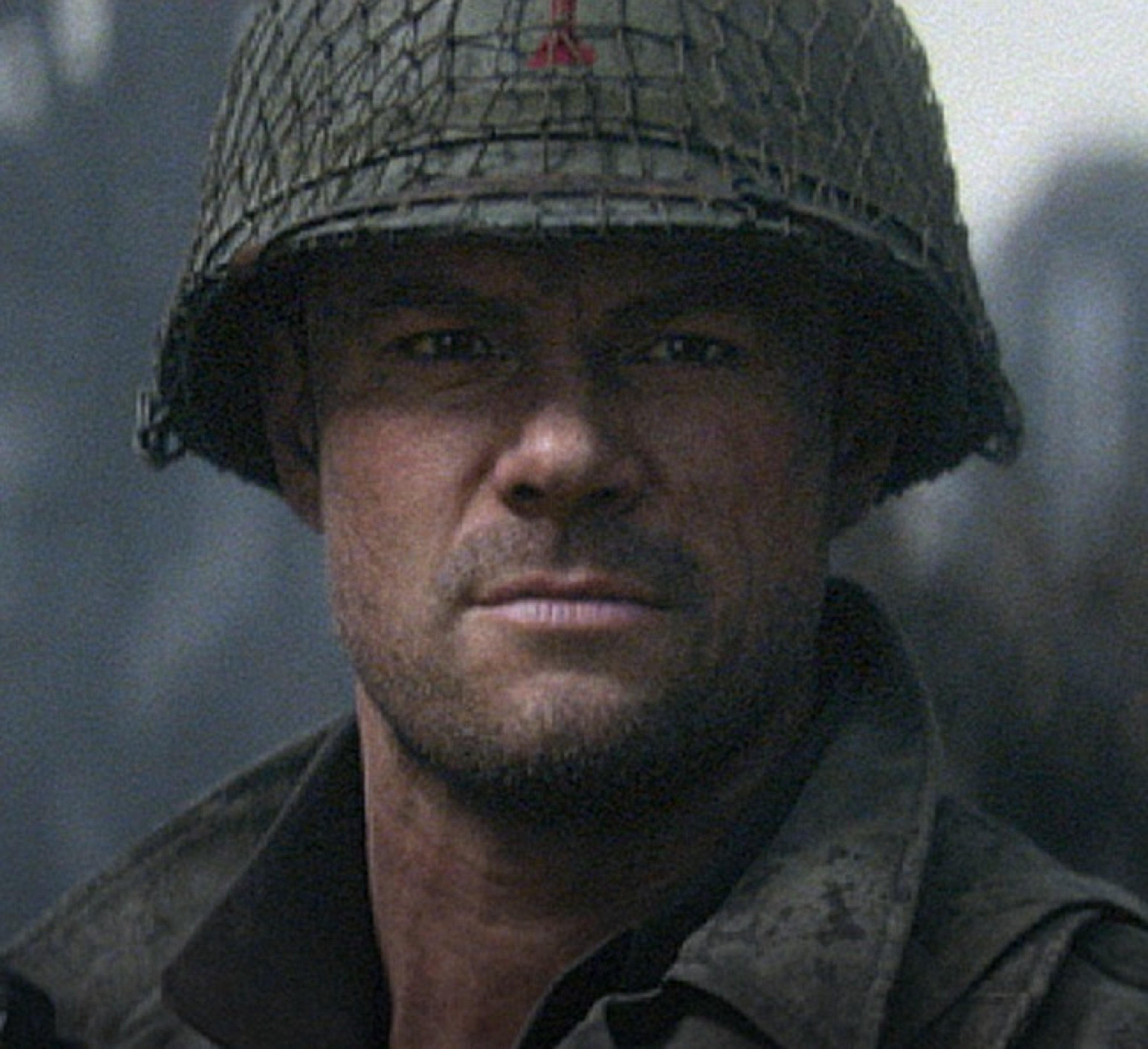 A World War II-era American soldier with a serious expression