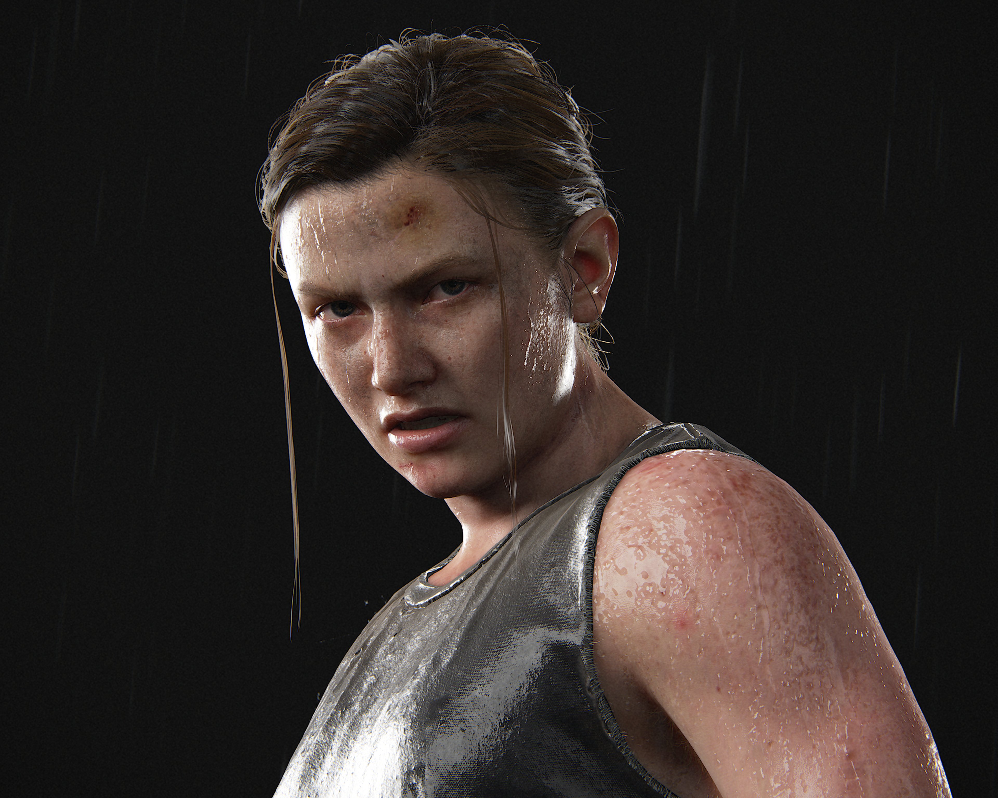 A muscular woman with short brown hair and a serious expression